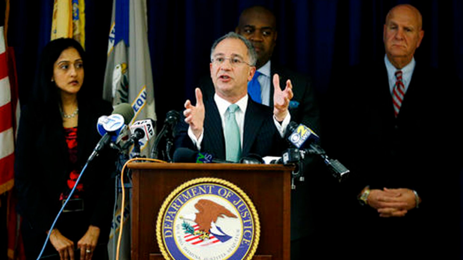 Paul Fishman, front, U.S. attorney for the District of New Jersey, stands with Vanita Gupta, left, principal deputy assistant attorney general for the U.S. Department of Justice Civil Rights Division, Newark Mayor Ras Baraka, center back, and Anthony Ambrose, right, Newark public safety director, while speaking during a news conference, Wednesday, March 30, 2016, in Newark, N.J.