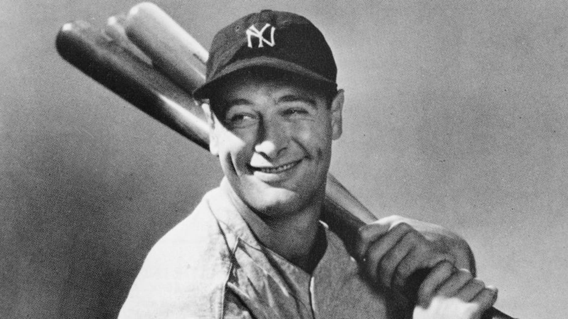 Portrait of New York Yankees first baseman, Lou Gehrig (1903 - 1941), seated with three baseball bats over his shoulder, circa 1930s. (Photo by Pictorial Parade/Getty Images)