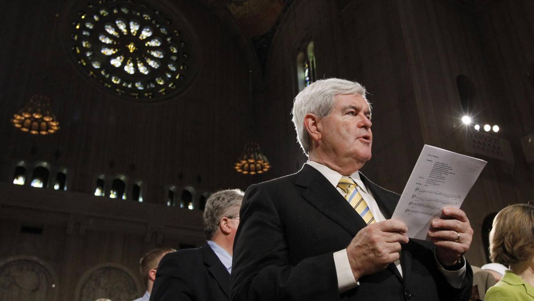 Former Speaker Newt Gingrich sings during Easter Mass at the Basilica of the National Shrine of the Immaculate Conception Roman Catholic Church Sunday, April 24, 2011 in Washington. (AP Photo/Alex Brandon)