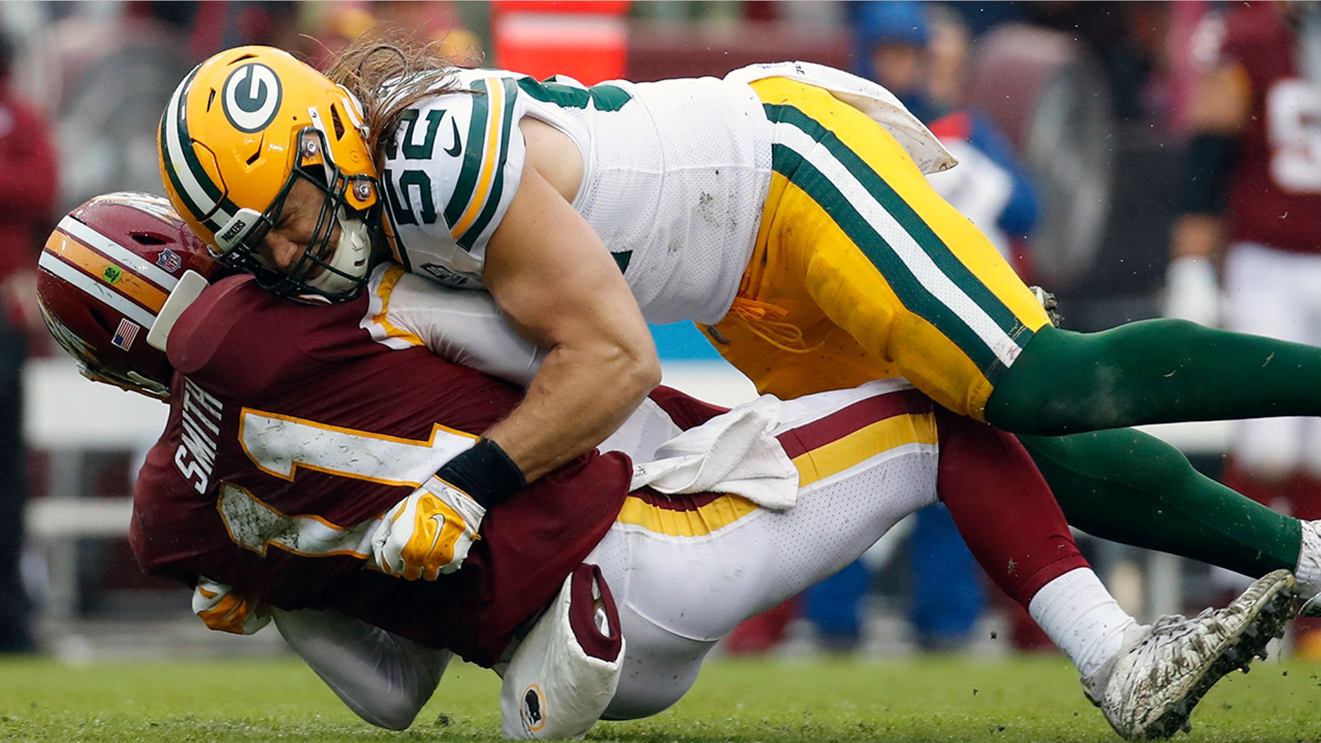 Green Bay Packers linebacker Clay Matthews (52) hits Washington Redskins quarterback Alex Smith (11) during the second half of their game.