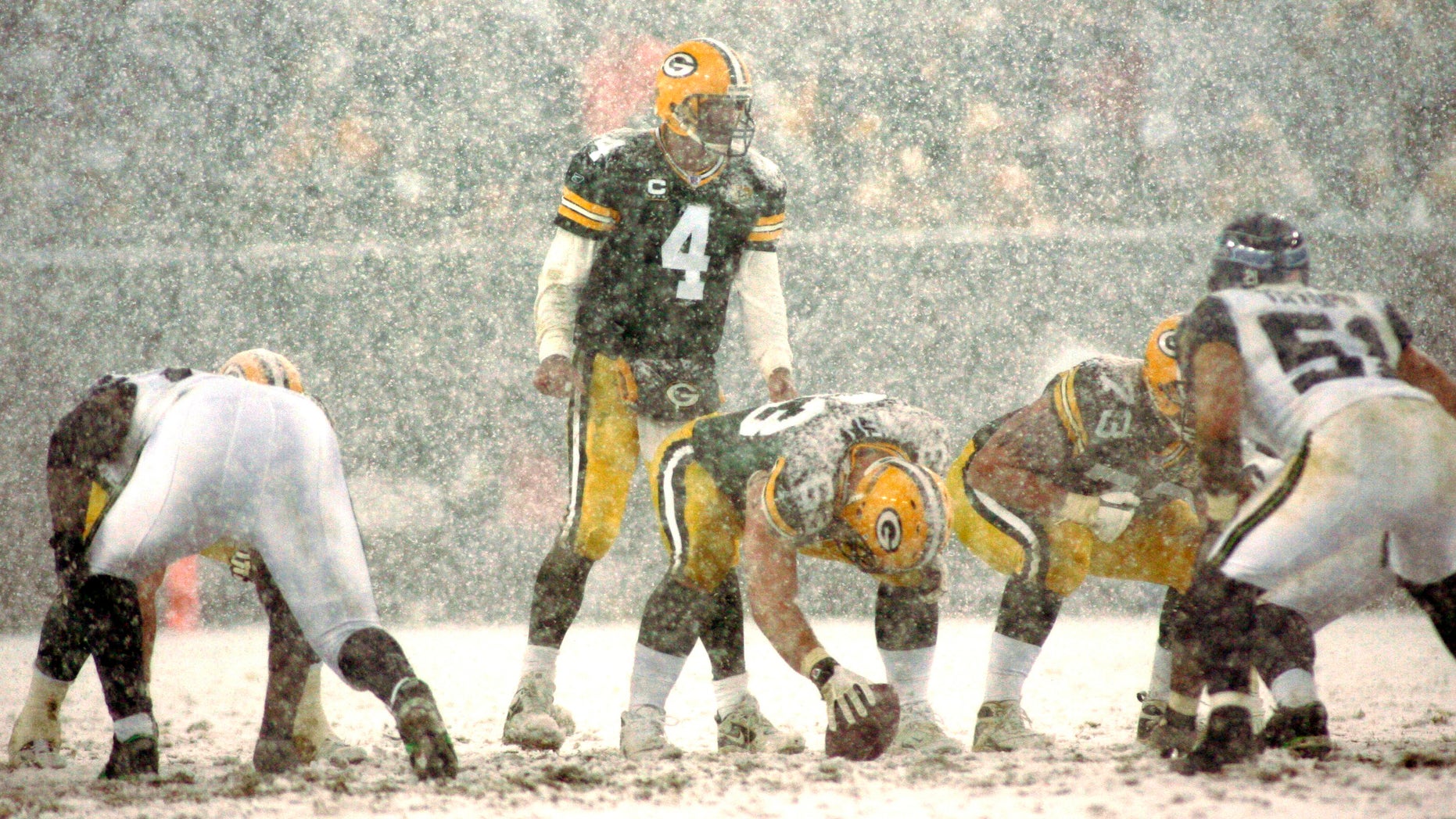 Green Bay Packers quarterback Brett Favre (C) calls a play as heavy snow falls in the second half against the Seattle Seahawks during their NFC Divisional NFL playoff football game in Green Bay, Wisconsin, January 12, 2008.