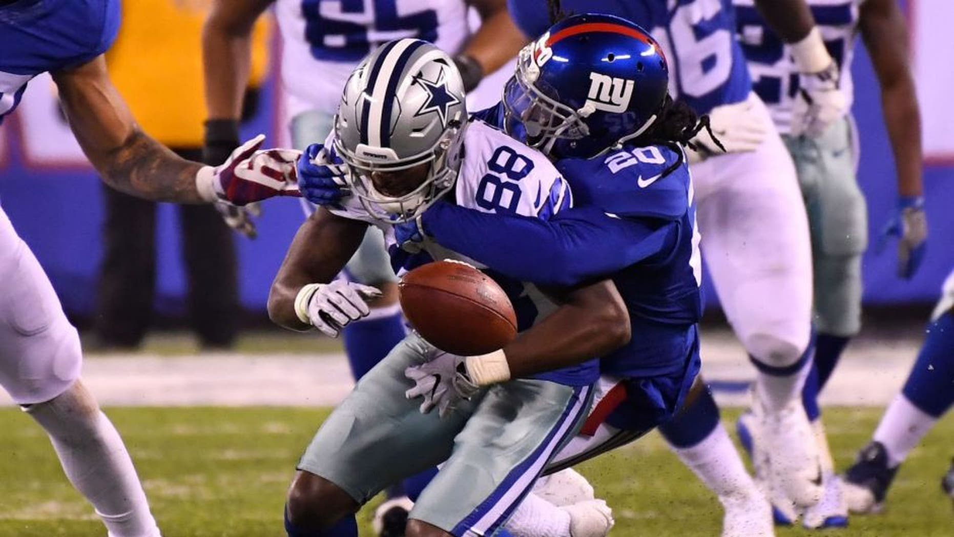 Dec 11, 2016; East Rutherford, NJ, USA; Dallas Cowboys wide receiver Dez Bryant (88) fumbles the ball late in the fourth quarter as New York Giants cornerback Janoris Jenkins (20) makes the hit at MetLife Stadium. Mandatory Credit: Robert Deutsch-USA TODAY Sports