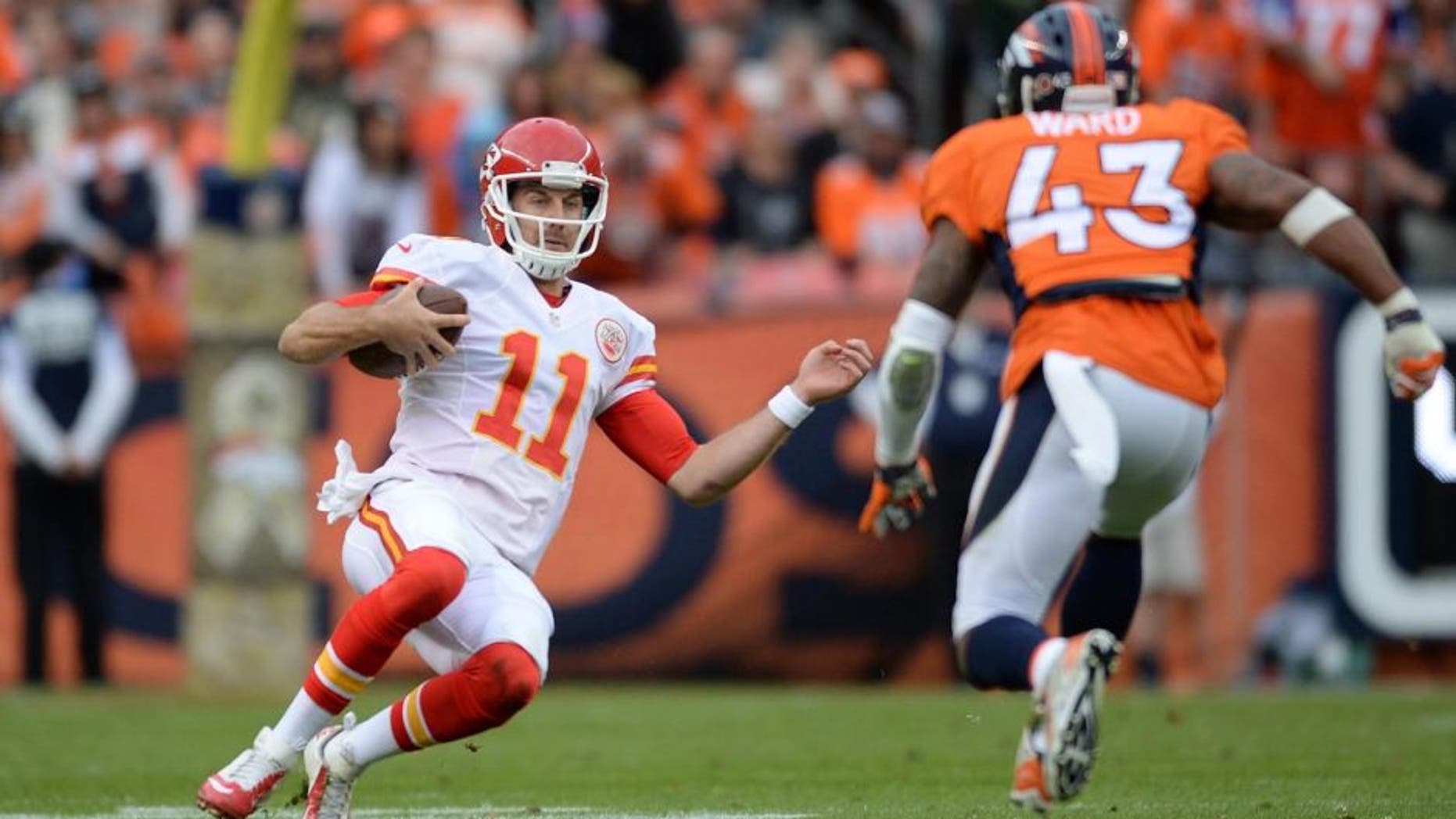 Nov 15, 2015; Denver, CO, USA; Kansas City Chiefs quarterback Alex Smith (11) slides as Denver Broncos strong safety T.J. Ward (43) closes in in the second quarter at Sports Authority Field at Mile High. Mandatory Credit: Ron Chenoy-USA TODAY Sports