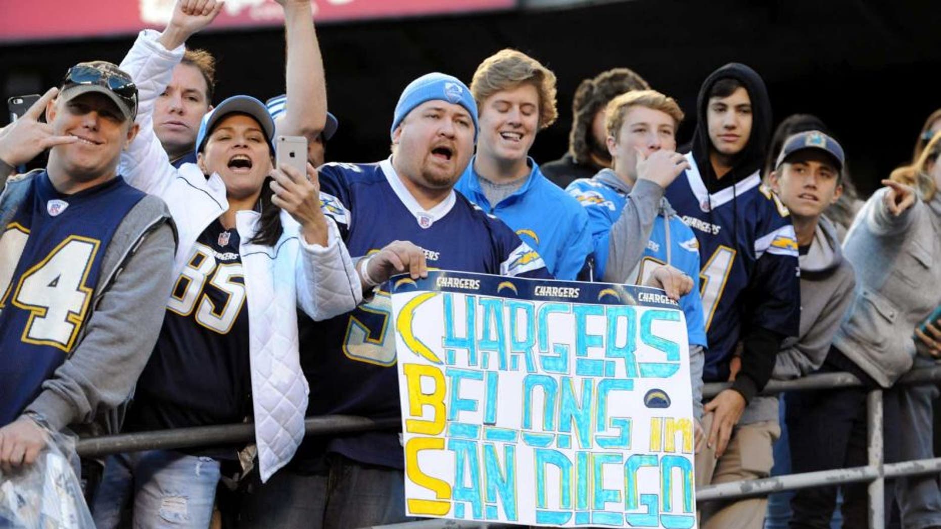 Jan 1, 2017; San Diego, CA, USA; A San Diego Chargers fan holds up a sign referencing the possible move to Los Angeles by the team during the second half of the game against the Kansas City Chiefs at Qualcomm Stadium. The Chiefs won 37-27. Mandatory Credit: Orlando Ramirez-USA TODAY Sports