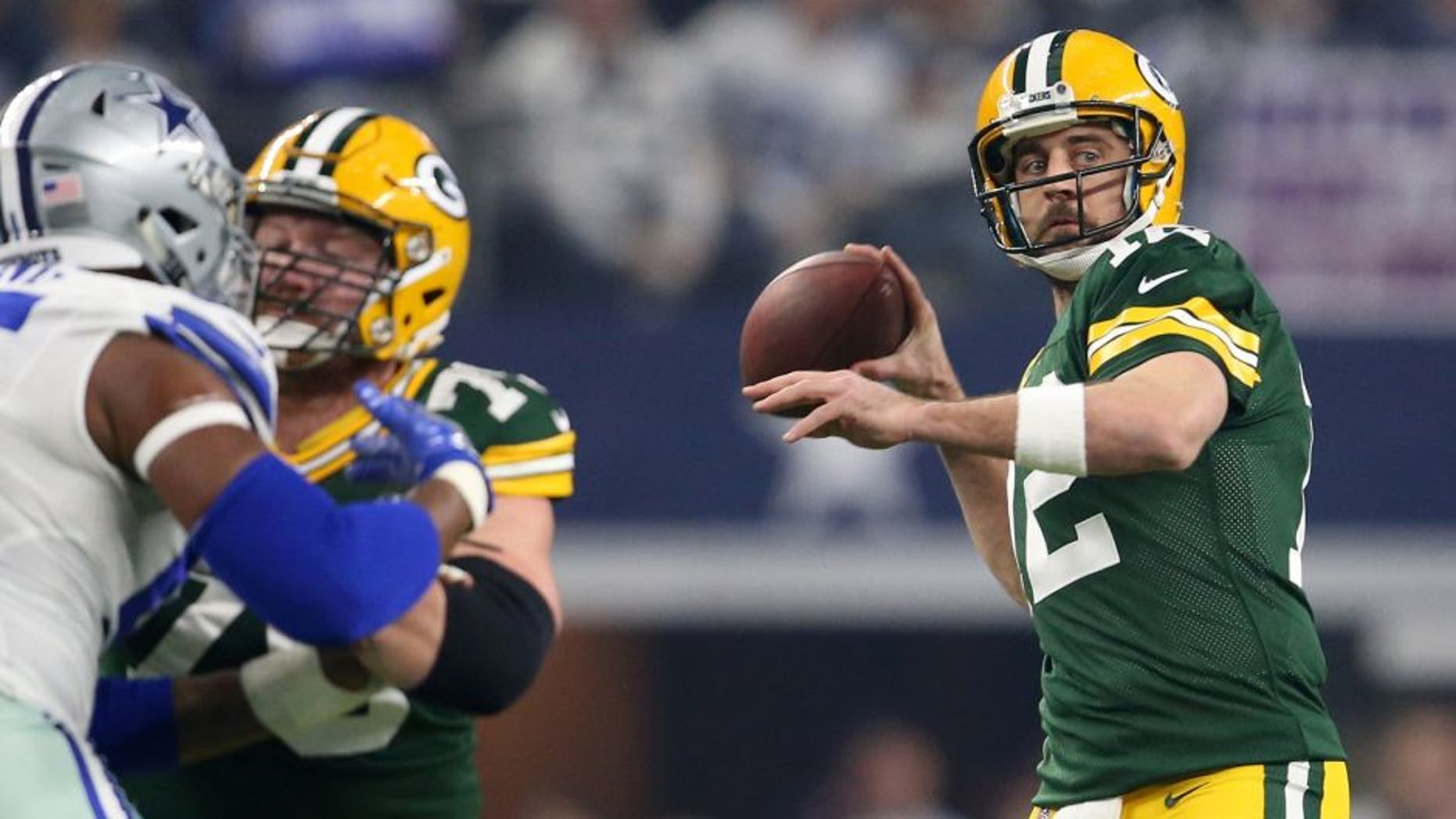 Jan 15, 2017; Arlington, TX, USA; Green Bay Packers quarterback Aaron Rodgers (12) throws a pass against the Dallas Cowboys during the first quarter in the NFC Divisional playoff game at AT&T Stadium. Mandatory Credit: Matthew Emmons-USA TODAY Sports