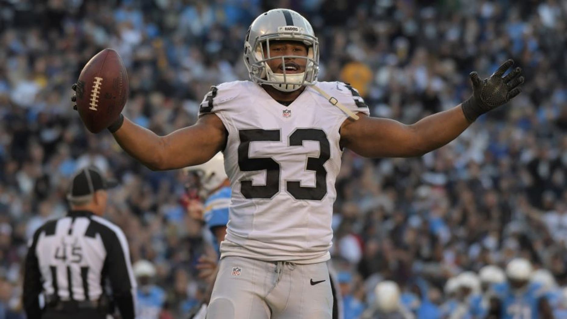 Dec 18, 2016; San Diego, CA, USA; Oakland Raiders linebacker Malcolm Smith (53) celebrates after a fumble recovery in the fourth quarter against the San Diego Chargers during a NFL football game at Qualcomm Stadium. The Raiders defeated the Chargers 19-16. Mandatory Credit: Kirby Lee-USA TODAY Sports