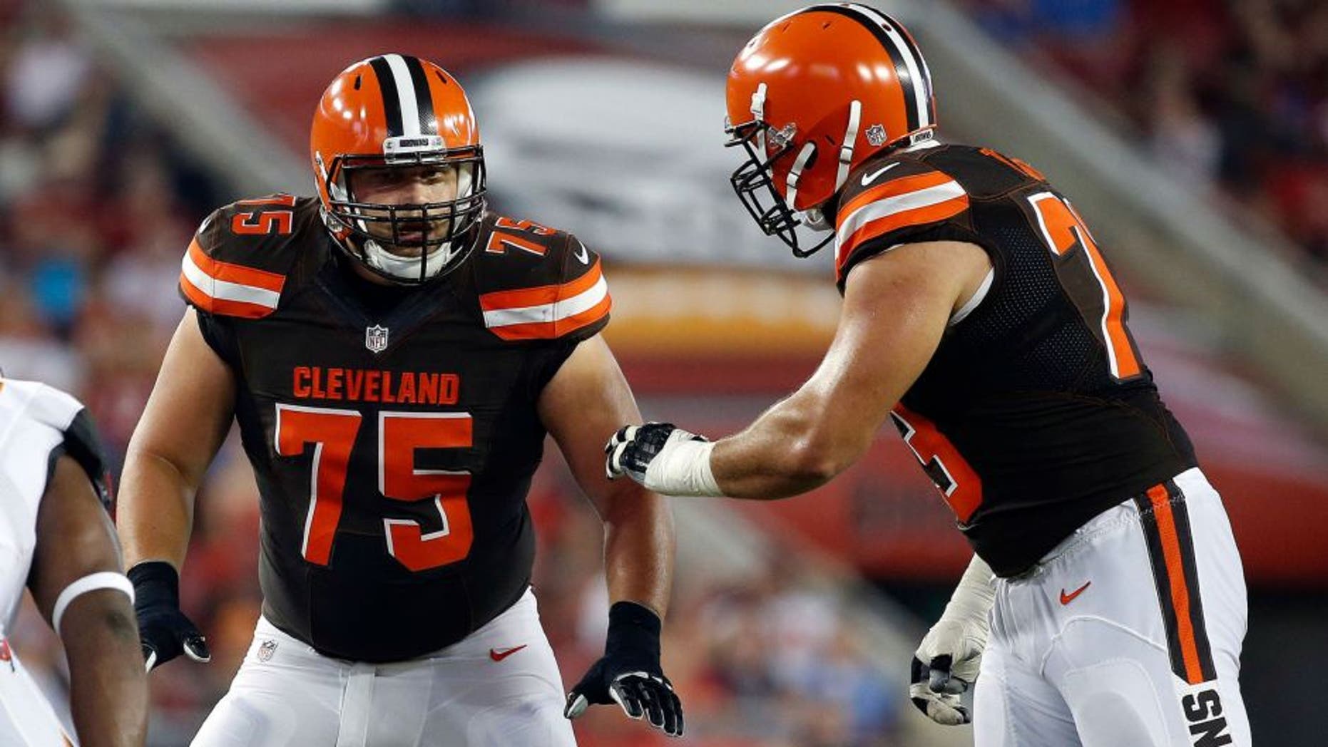 Aug 26, 2016; Tampa, FL, USA; Cleveland Browns guard Joel Bitonio (75) and tackle Joe Thomas (73) talk against the Tampa Bay Buccaneers during the first quarter at Raymond James Stadium. Mandatory Credit: Kim Klement-USA TODAY Sports