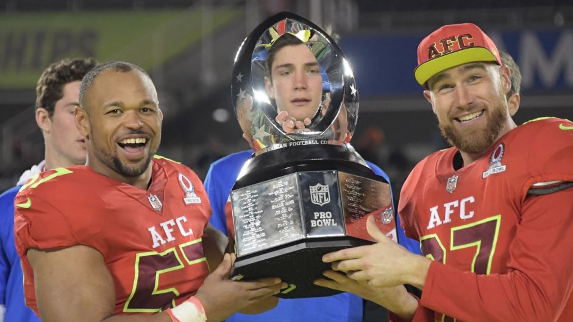 Jan 29, 2017; Orlando, FL, USA; AFC linebacker Lorenzo Alexander of the Buffalo Bills (57) and tight end Travis Kelce of the Kansas City Chiefs (87) hold the Pro Bowl trophy after the 2017 Pro Bowl at Camping World Stadium. The AFC defeated the NFC 20-13. Mandatory Credit: Kirby Lee-USA TODAY Sports