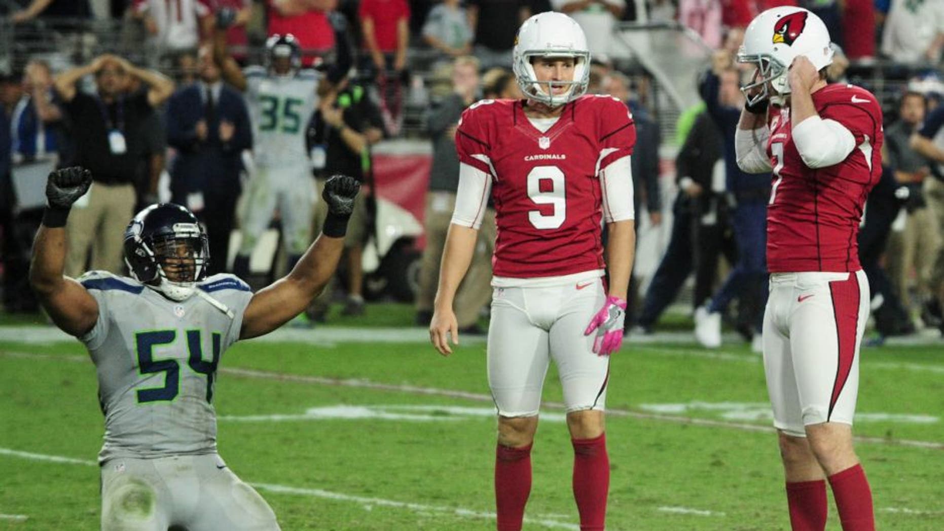Oct 23, 2016; Glendale, AZ, USA; Arizona Cardinals kicker Chandler Catanzaro (7) reacts after missing a field goal in overtime as punter Ryan Quigley (9) and Seattle Seahawks middle linebacker Bobby Wagner (54) react at University of Phoenix Stadium. Mandatory Credit: Matt Kartozian-USA TODAY Sports
