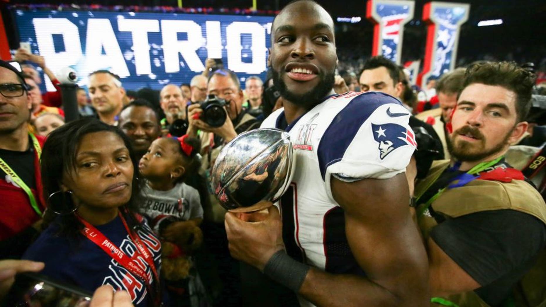 Feb 5, 2017; Houston, TX, USA; New England Patriots linebacker Barkevious Mingo (51) celebrates with the Lombardi Trophy after defeating the Atlanta Falcons during Super Bowl LI at NRG Stadium. The Patriots won 34-28. Mandatory Credit: Dan Powers-USA TODAY Sports