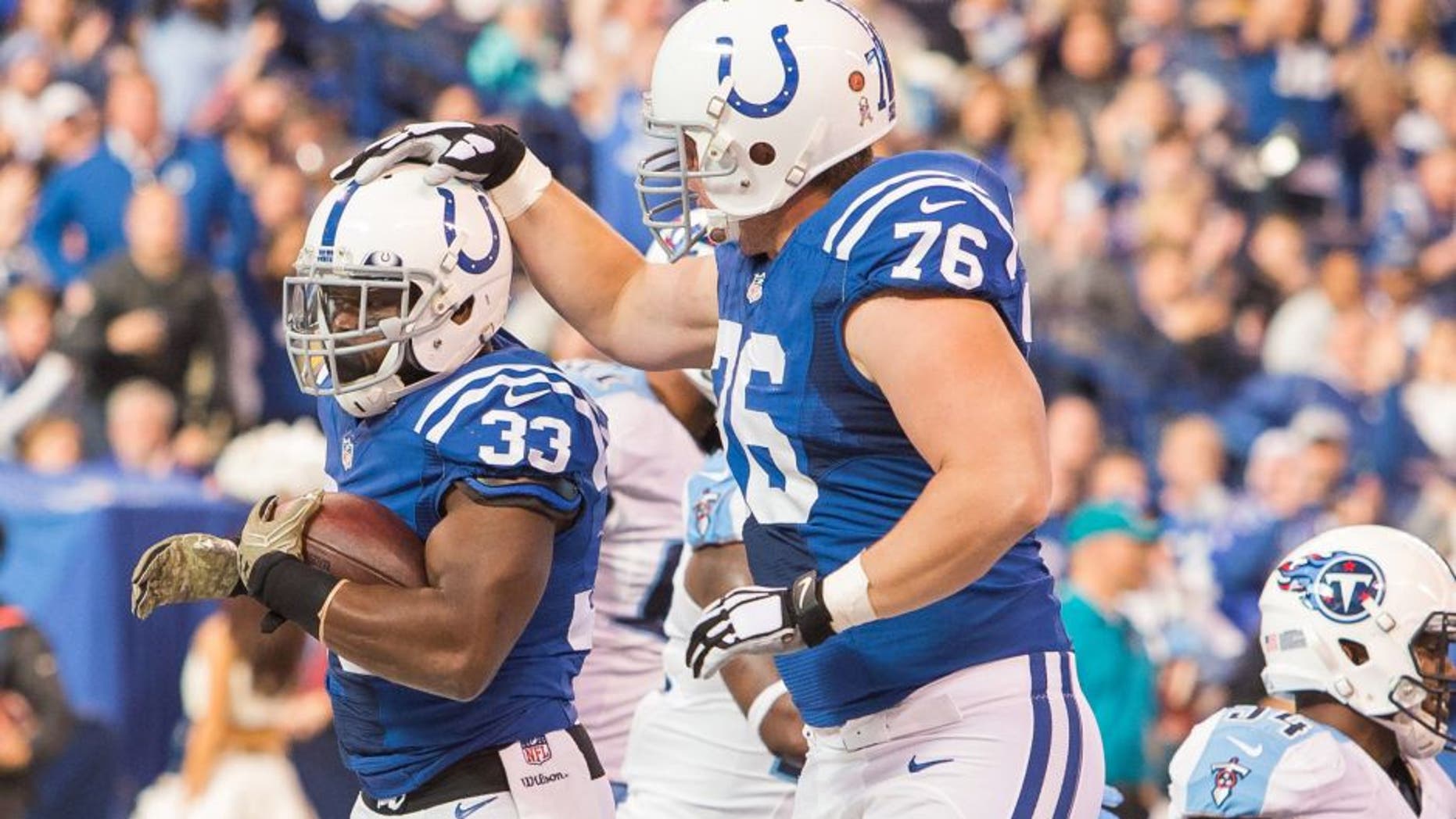 Nov 20, 2016; Indianapolis, IN, USA; Indianapolis Colts running back Robert Turbin (33) celebrates his touchdown with offensive tackle Joe Reitz (76) in the first quarter the game against the Tennessee Titans at Lucas Oil Stadium. Mandatory Credit: Trevor Ruszkowski-USA TODAY Sports