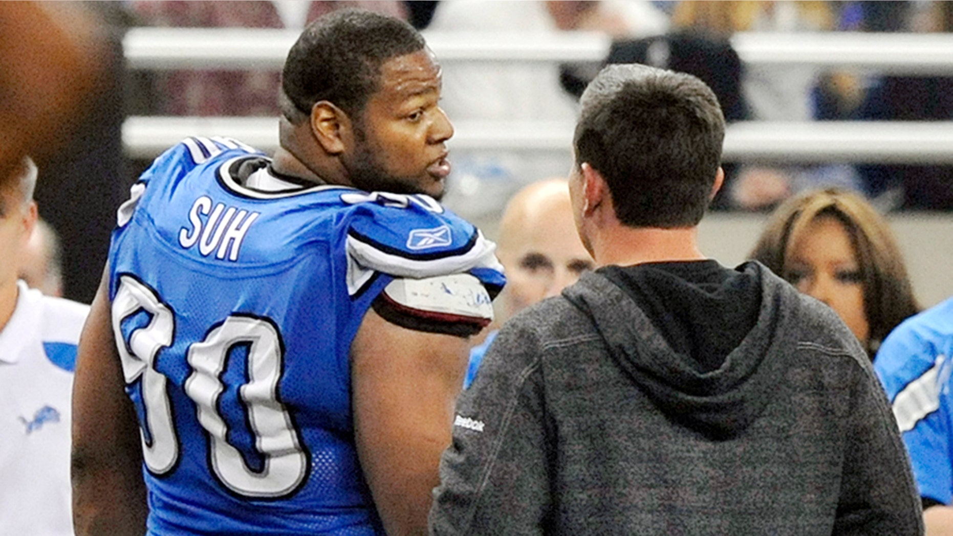 FILE - In this file photo taken Nov. 24, 201, Detroit Lions head coach Jim Schwartz talks with defensive tackle Ndamukong Suh (90) as he leaves the field after being disqualified in the third quarter during an NFL football game against the Green Bay Packers at Ford Field in Detroit. The Packers won 27-15. Suh was ejected from the game after he stepped on a Packers offensive lineman. (AP Photo/The Detroit News, Robin Buckson, File)