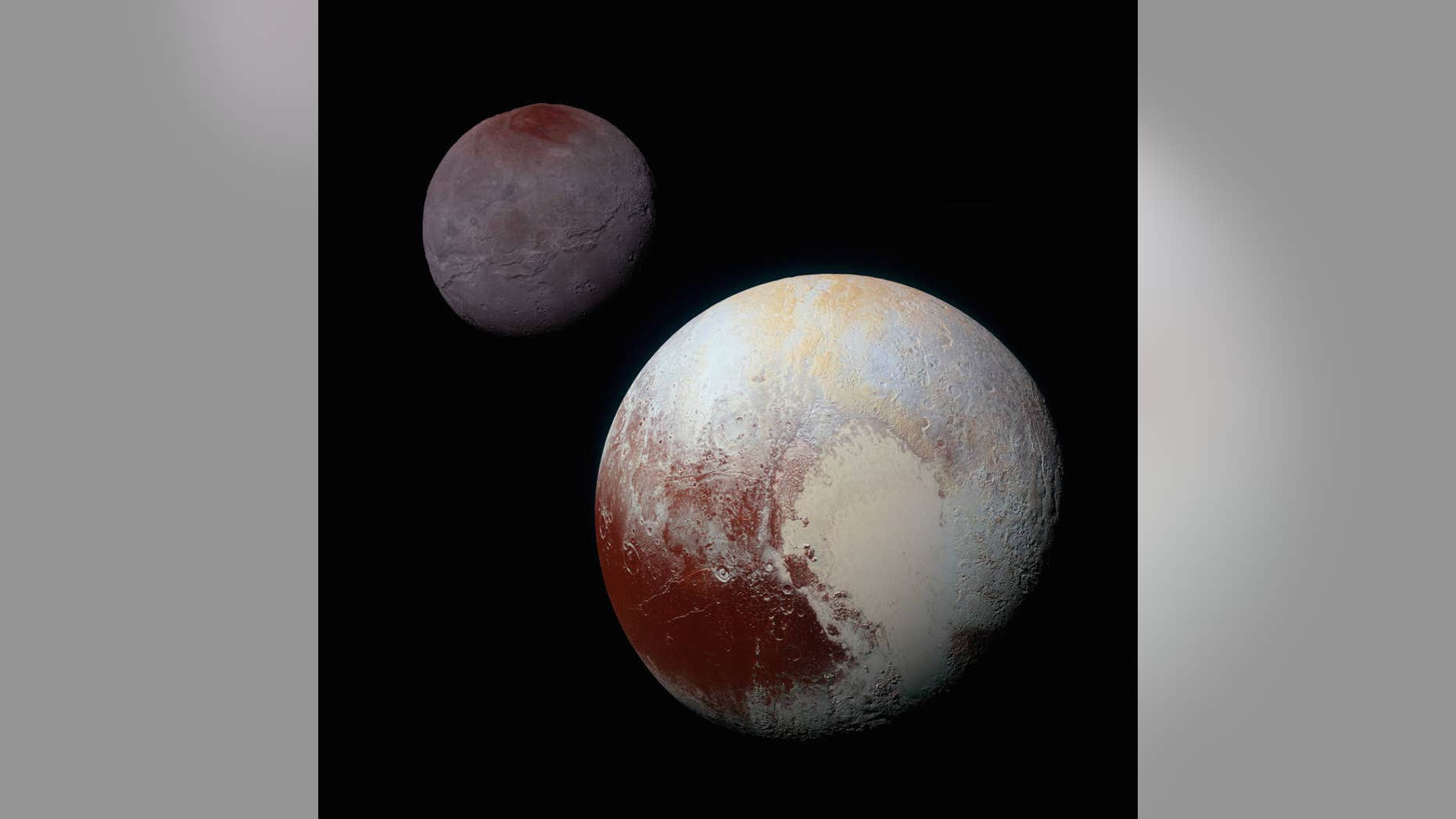 This composite, enhanced-color image of Pluto (lower right) and its largest moon, Charon (upper left), was taken by NASA's New Horizons spacecraft on July 14, 2015. Pluto and Charon are shown with approximately correct relative sizes, but their true separation is not to scale.