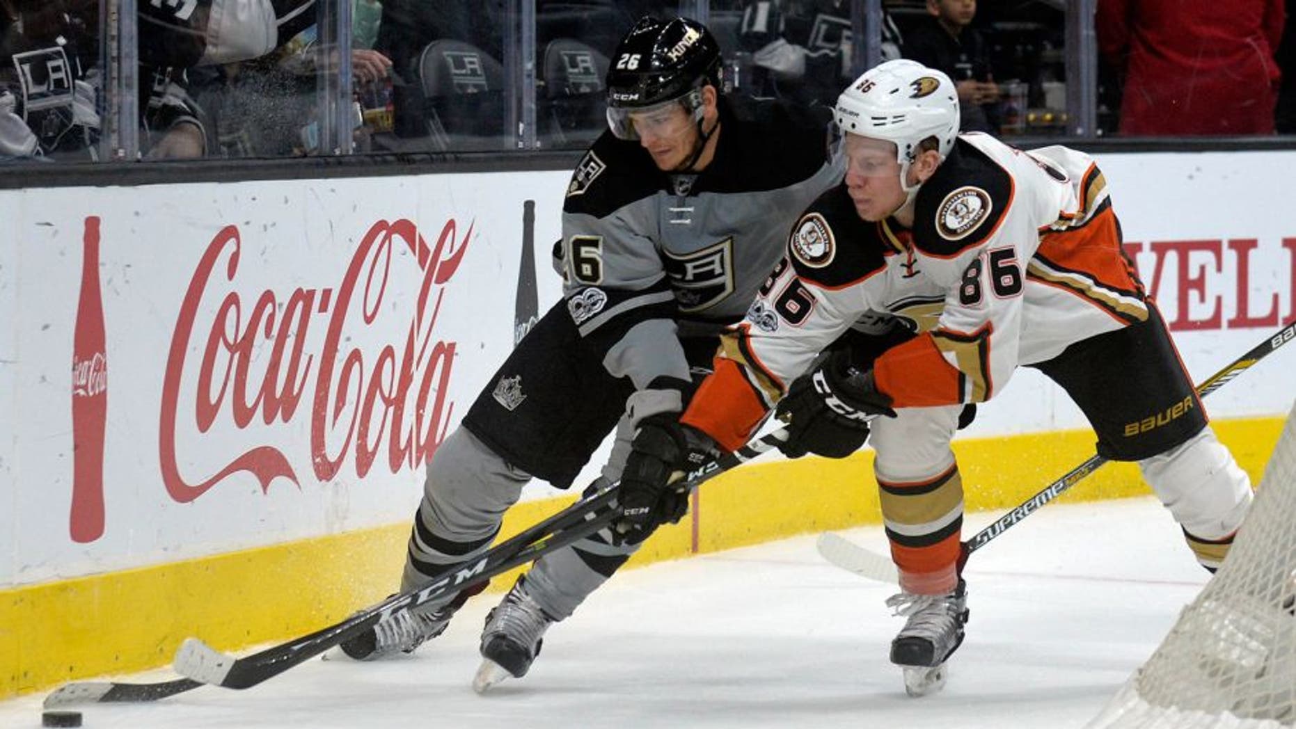 February 25, 2017; Los Angeles, CA, USA; Los Angeles Kings center Nic Dowd (26) plays for the puck against Anaheim Ducks right wing Ondrej Kase (86) during the third period at Staples Center. Mandatory Credit: Gary A. Vasquez-USA TODAY Sports