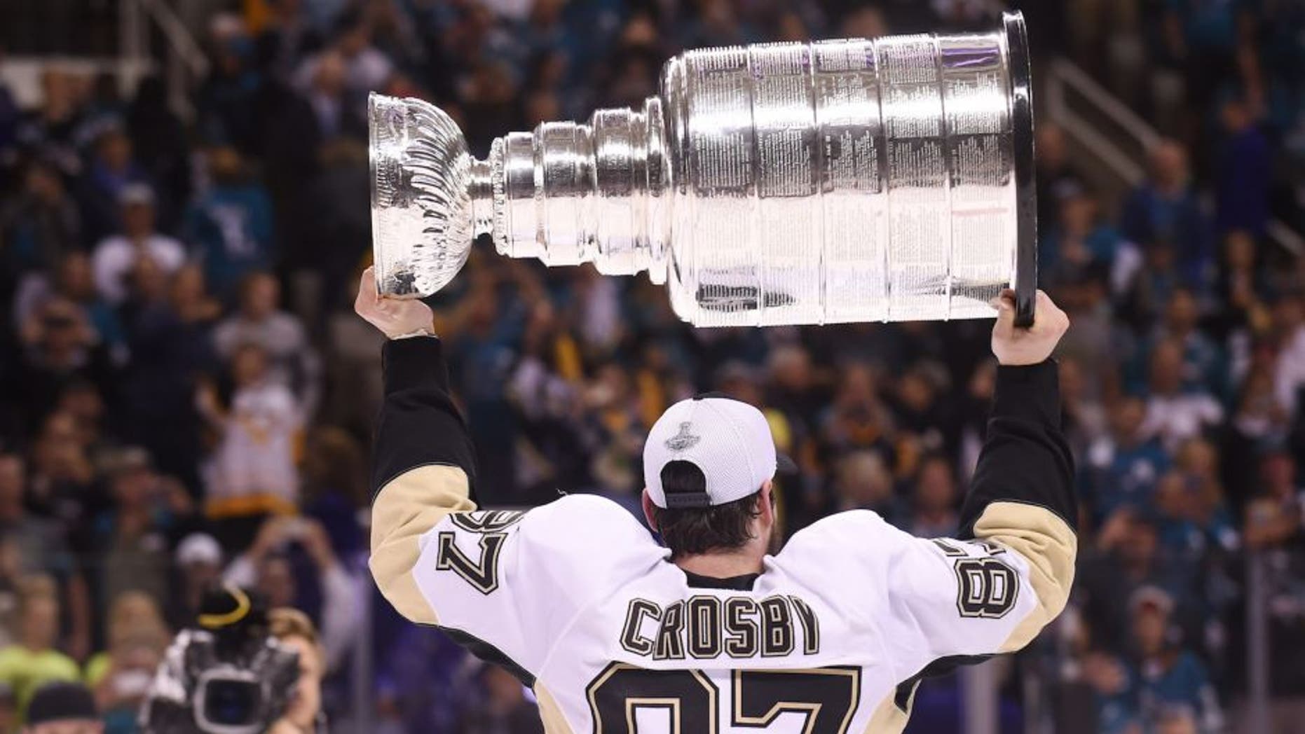 Jun 12, 2016; San Jose, CA, USA; Pittsburgh Penguins center Sidney Crosby (87) hoists the Stanley Cup after defeating the San Jose Sharks in game six of the 2016 Stanley Cup Final at SAP Center at San Jose. Mandatory Credit: Gary A. Vasquez-USA TODAY Sports