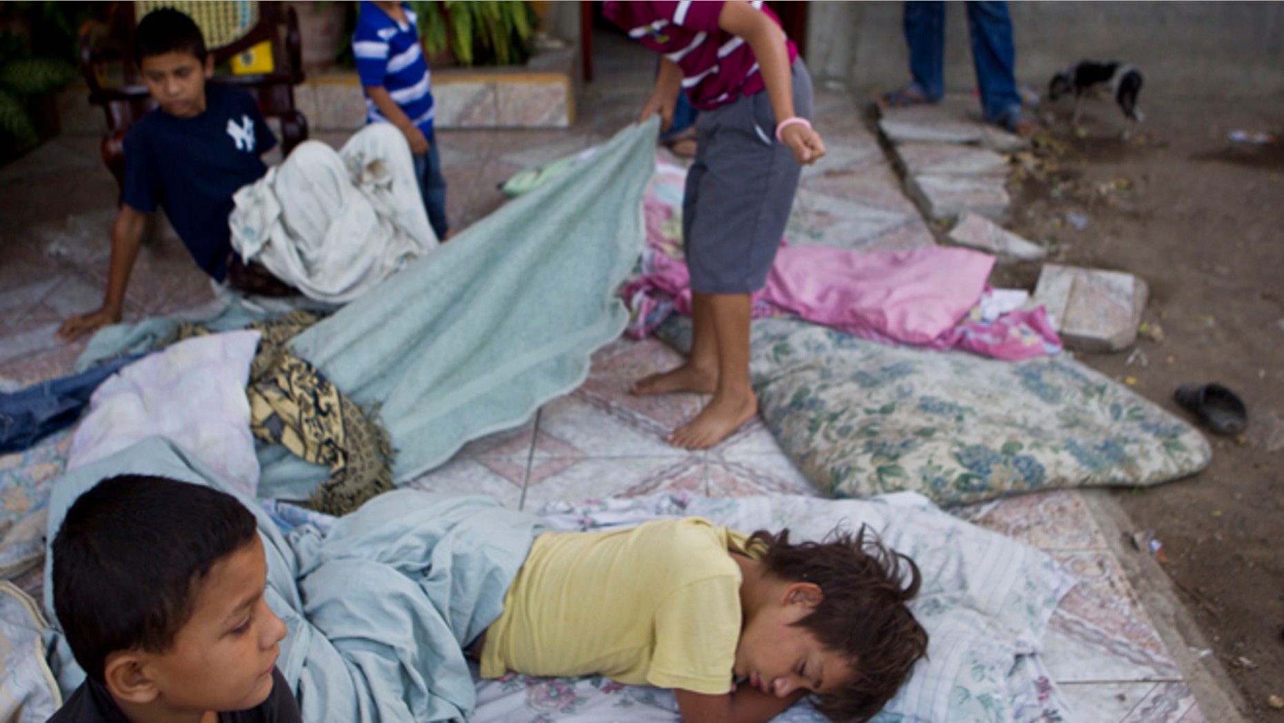 Apr. 11, 2014: Children lie on a mattress outside their home after a strong earthquake in Nagarote, Nicaragua.