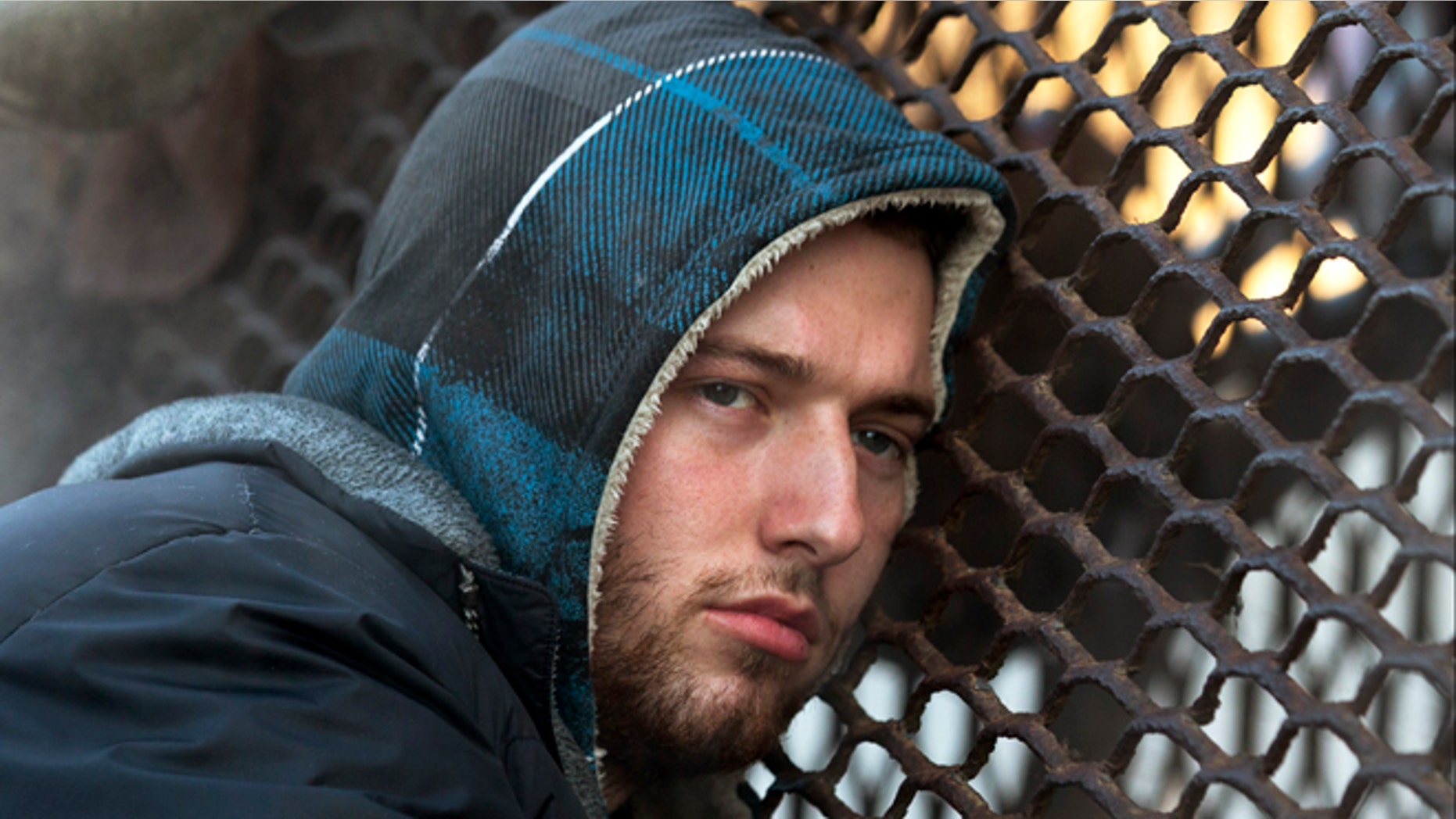 Jan. 4, 2014: Nicholas Simmons, 20, of Greece, N.Y., warms himself on a steam grate with three homeless men by the Federal Trade Commission, in Washington.