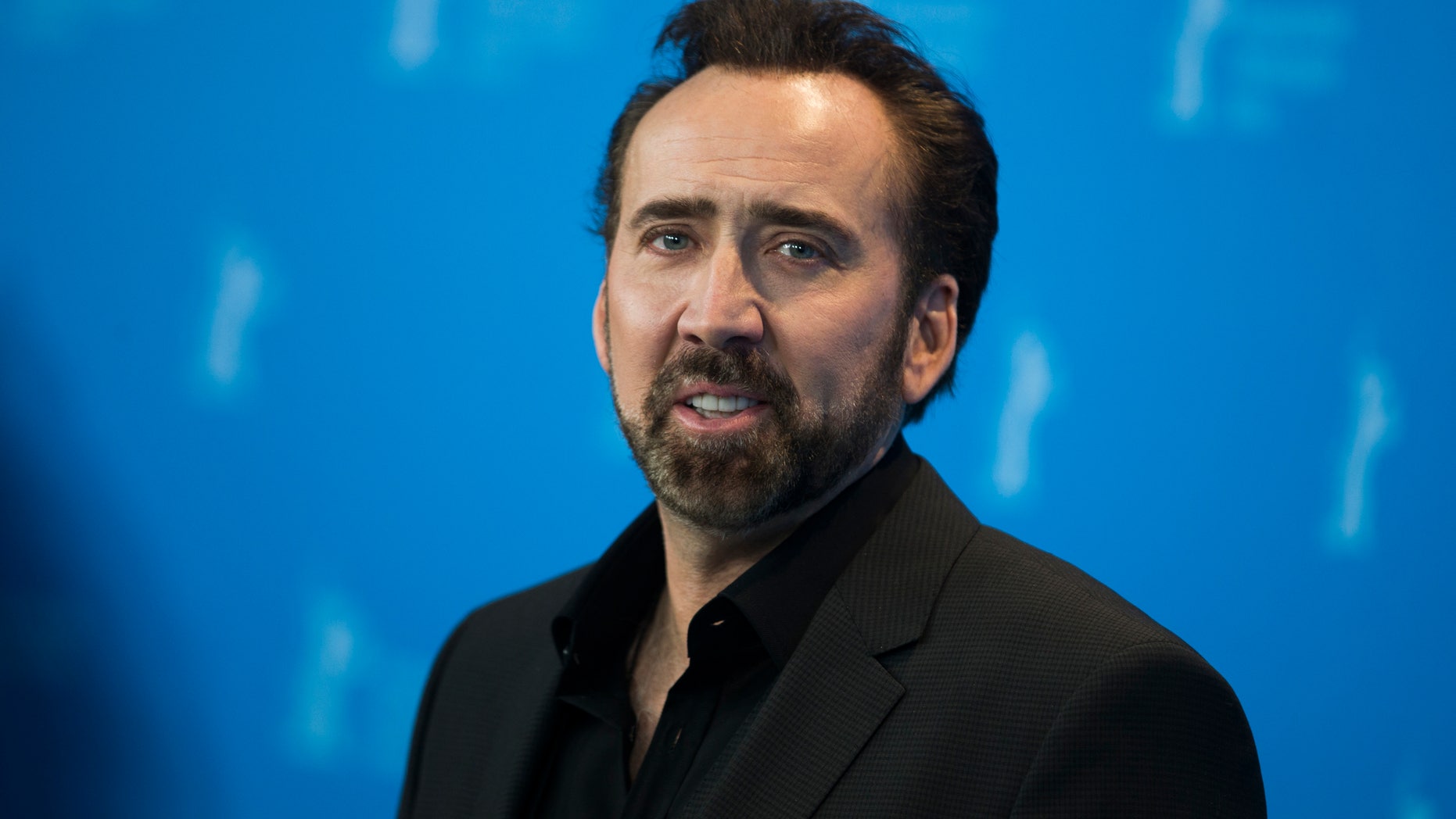 Nicolas Cage, the voice of the character Grug, poses during a photocall promoting the animation movie "The Croods" at the 63rd Berlinale International Film Festival in Berlin February 15, 2013. REUTERS/Thomas Peter (GERMANY - Tags: ENTERTAINMENT) - RTR3DU1U