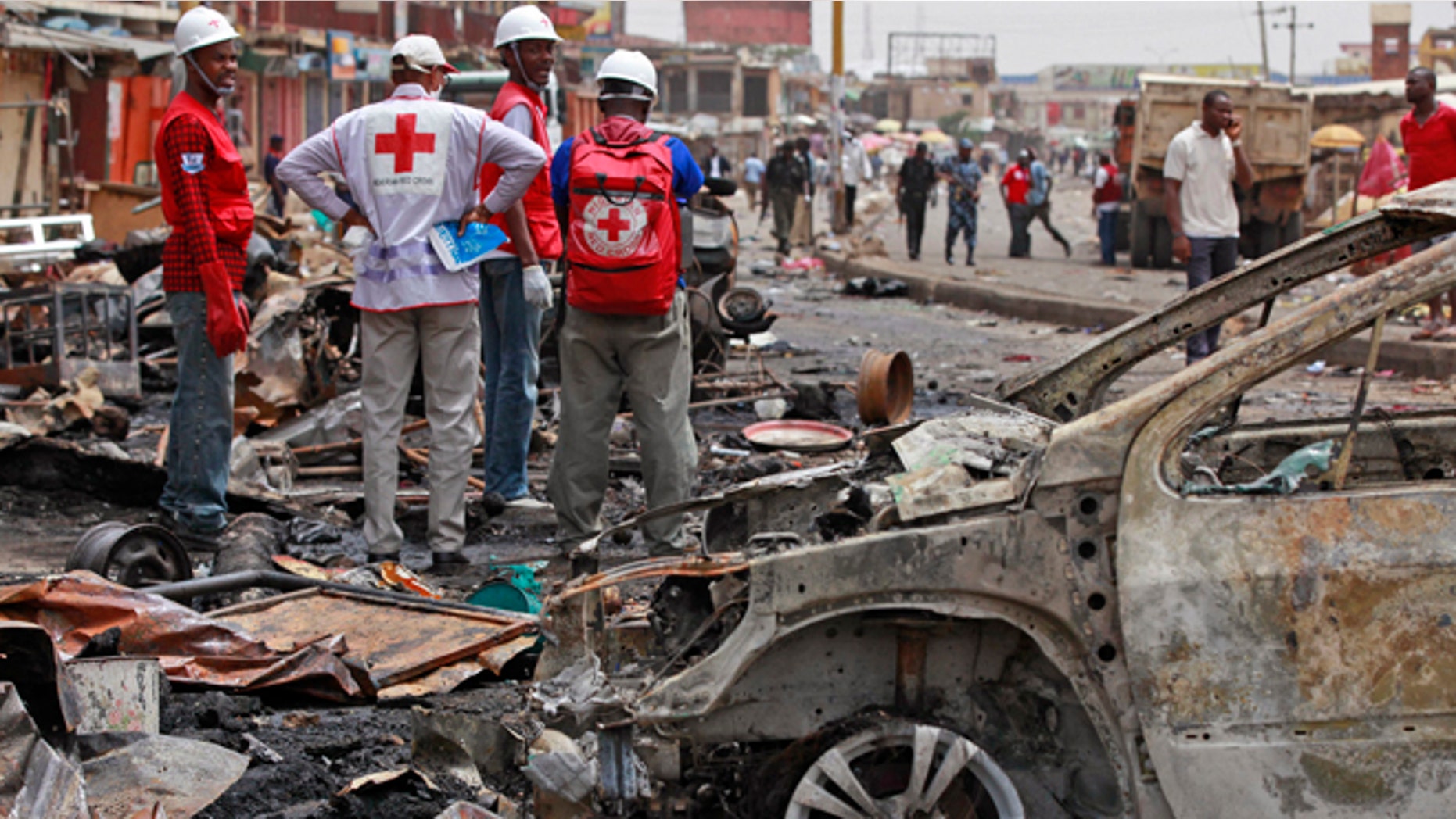 May 21, 2014: Red Cross personnel search for remains at the site of one of a car bomb in Jos, Nigeria. Boko Haram militants are taking over villages in northeastern Nigeria, killing and terrorizing civilians and political leaders. (AP/Sunday Alamba/File)