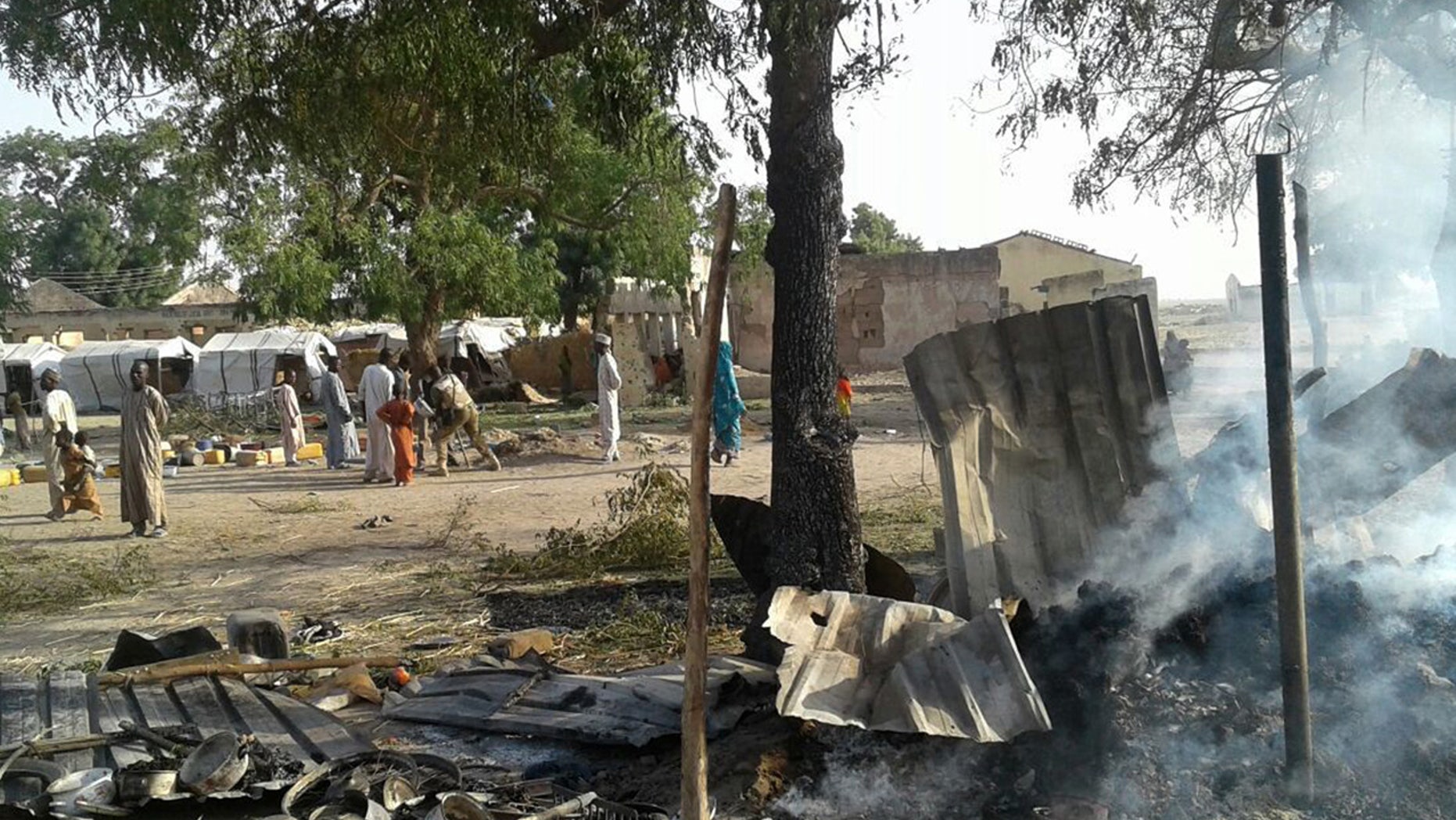 In this image supplied by MSF, smoke rises from a burnt out shelter at a camp for displaced people in Rann, Nigeria, Tuesday Jan. 17, 2017.