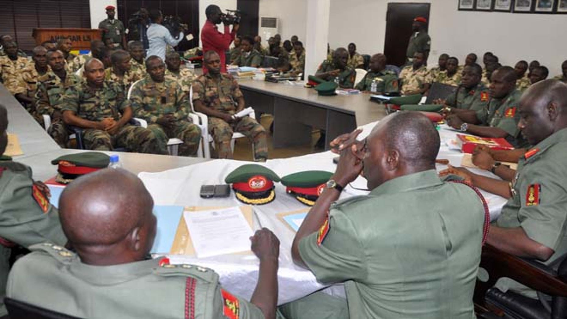 Oct. 15, 2014: In this file photo, soldiers accused of refusing to fight in the country's northeastern Islamic uprising appear before a court martial in Abuja, Nigeria. On Wednesday Dec. 17, 2014, the court-martial sentenced 54 soldiers to death for mutiny, assault, cowardice and refusing to fight Islamic extremists, connected to the soldiers' refusal to deploy to recapture three towns seized by Nigeria's home-grown Boko Haram in August, according to the charge sheet. The lawyer for the condemned men, Femi Falana, said the 54 soldiers were convicted and sentenced to death by firing squad. He said five soldiers were acquitted.