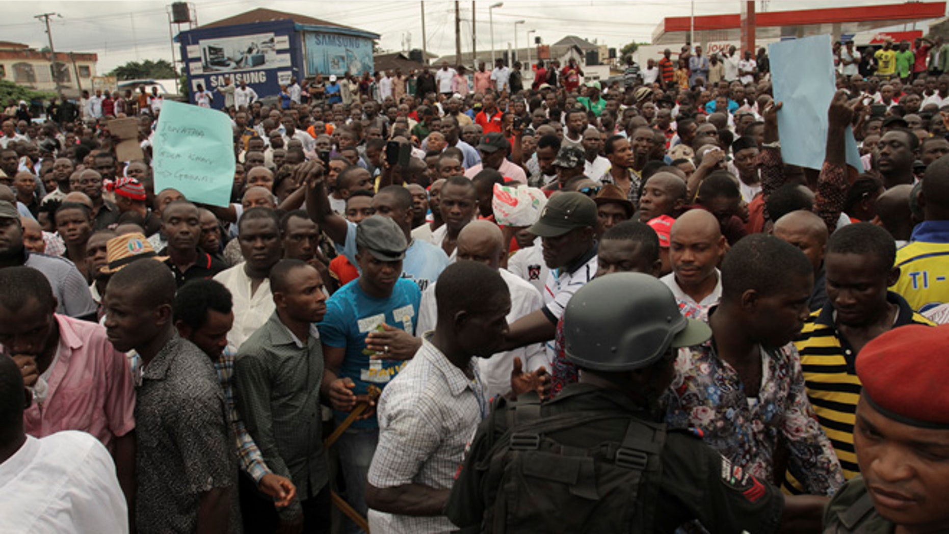 March 29, 2015: Security forces hold back protesters against the recent election in Port Harcourt , Nigeria.