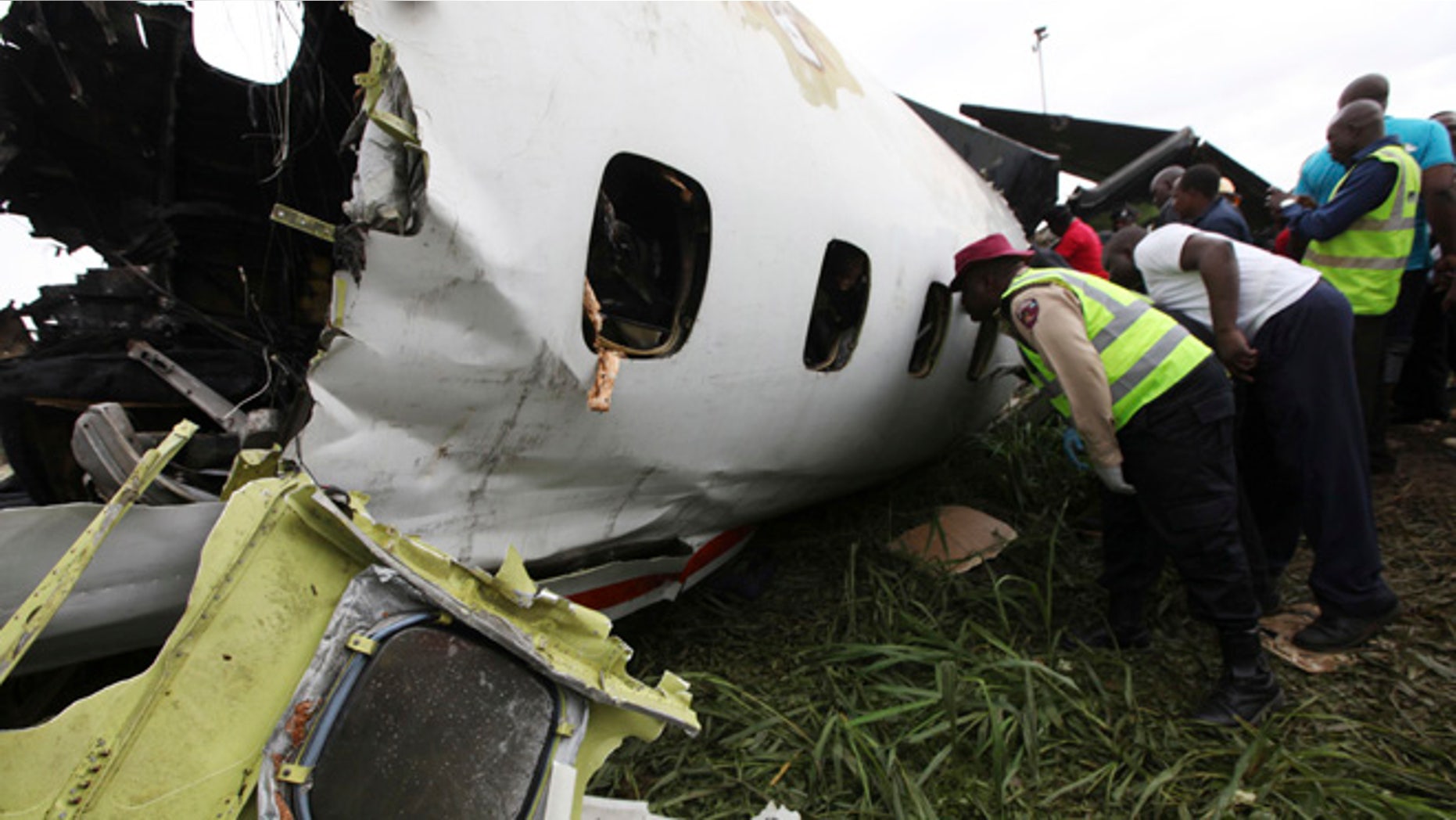 Oct. 3, 2013: Rescue workers peer into the wreckage of a charter passenger jet which crashed soon after take off from Lagos airport, Nigeria. Officials said there were casualties but refused to confirm reports of several deaths.