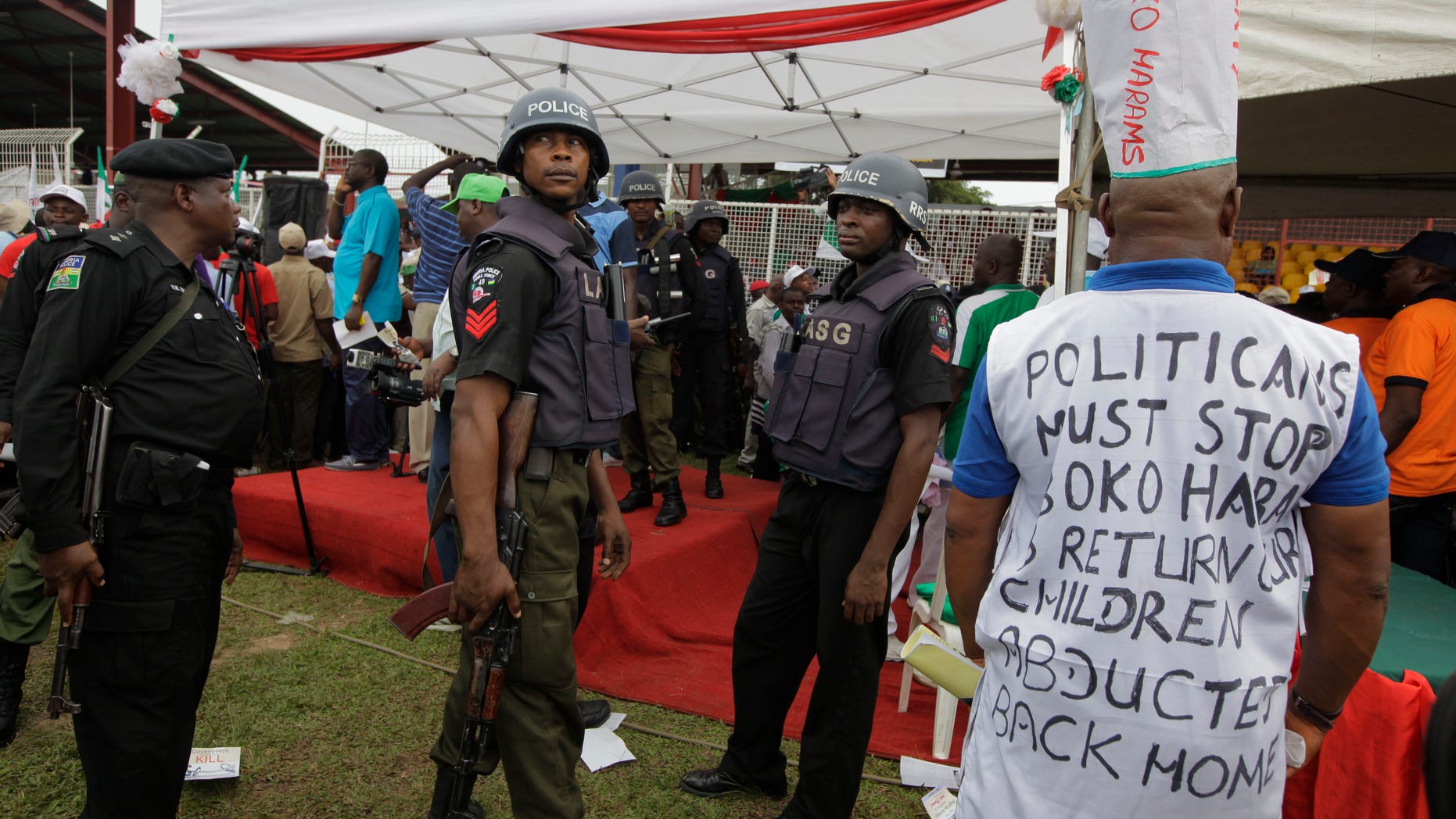 Police stand guard at a demonstration in Lagos calling on Nigeria's government to rescue kidnapped school girls. (Reuters)