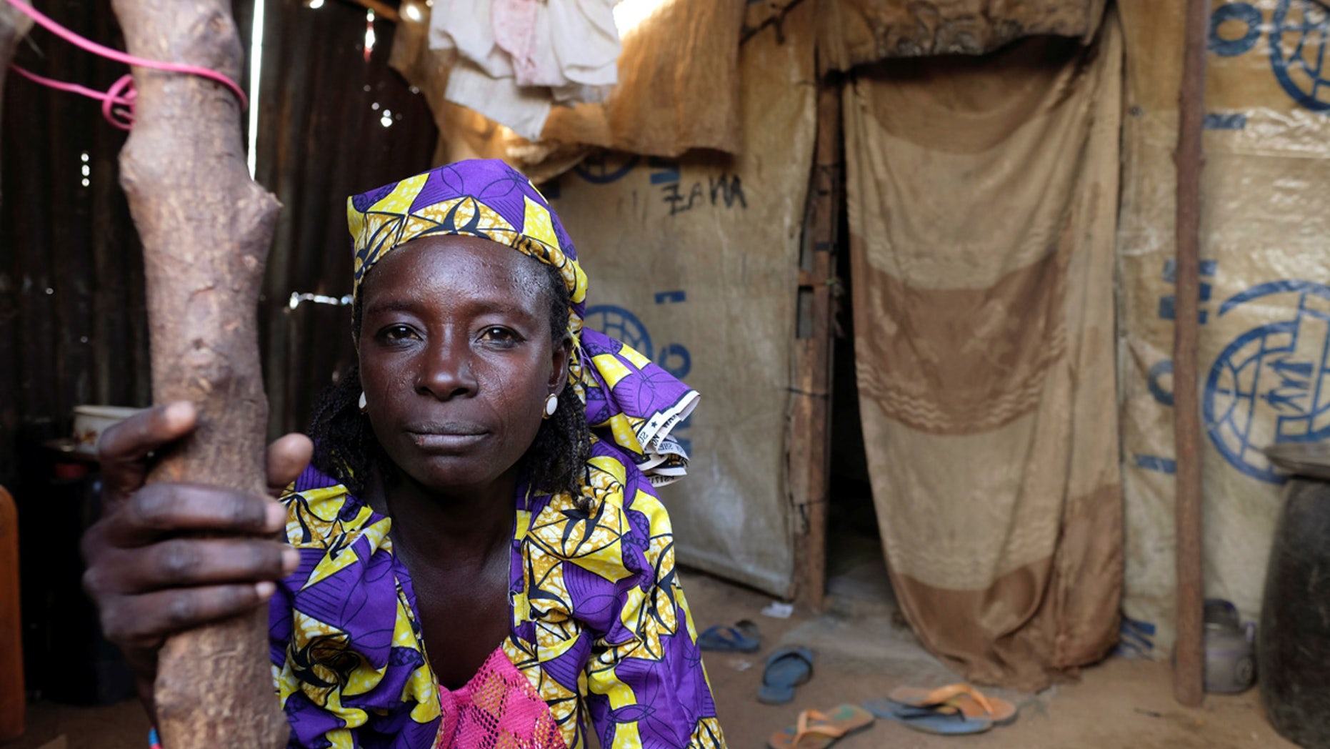 Zainab Bukar, an internally displaced person living in Bama camp, Nigeria, poses for a photograph in a shelter, Nov. 23, 2017.