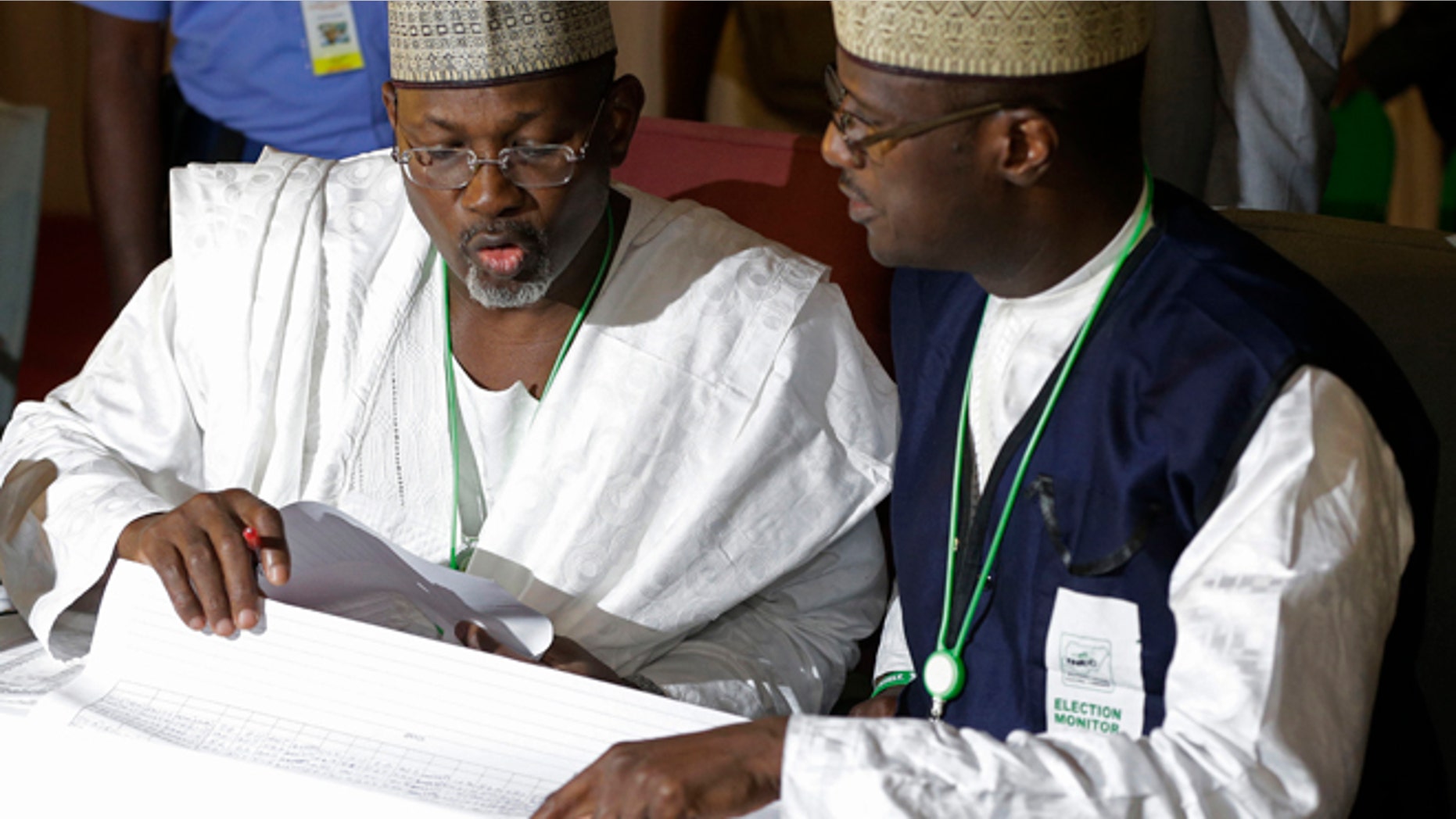 March 30, 2015: Independent National Electoral Commission chairman, Attahiru Jega, left, views election results at the coalition center in Abuja, Nigeria, Monday.