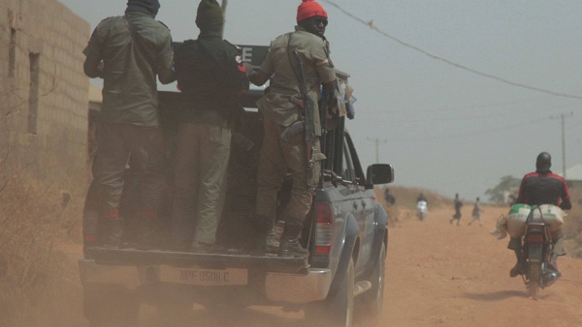 Security officers patrol the area near to the site where gunmen abducted German archaeologists professor Peter Breunig and his associate Johannes Behringer in Janjala Village, Nigeria. Friday, Feb. 24, 2017. Kidnappers are demanding a ransom of 60 million naira (about Dlrs 200,000 US) for the two captives abducted this week from Janjala village in northern Nigeria, the excavation site where the German archaeologists was working. Two villagers were shot and killed in the kidnapping, police confirmed Friday. (AP Photo/Lekan Oyekanmi )