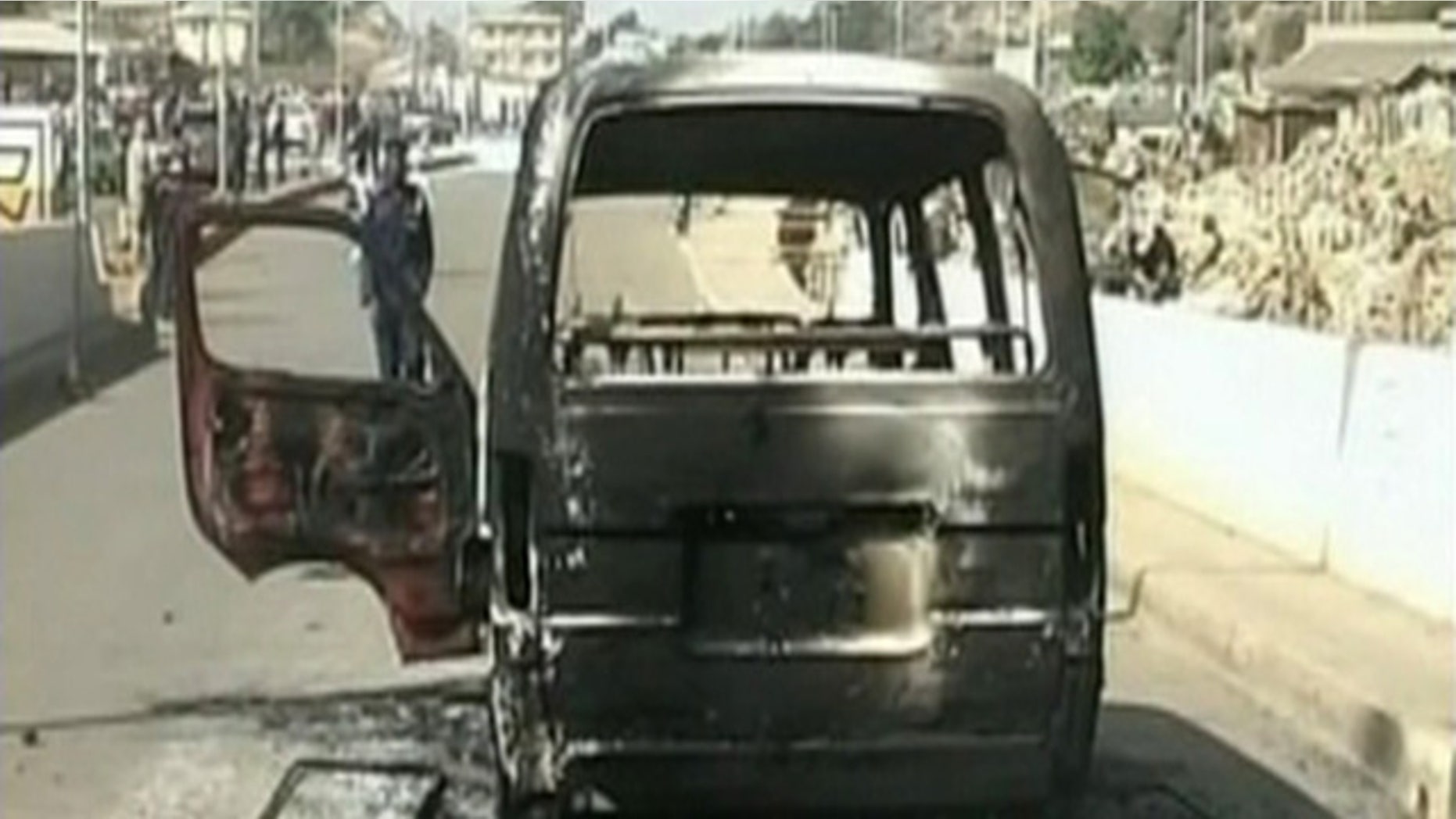 Dec. 25: In this image made from video provided NTA via APTN, a burned out van is seen on a road following violence in Jos, Nigeria. Dozens of people were killed over the holiday weekend in attacks across Nigeria, including 32 that died in central Nigeria in a series of bomb blasts in the worst violence to hit the region in months. (AP)