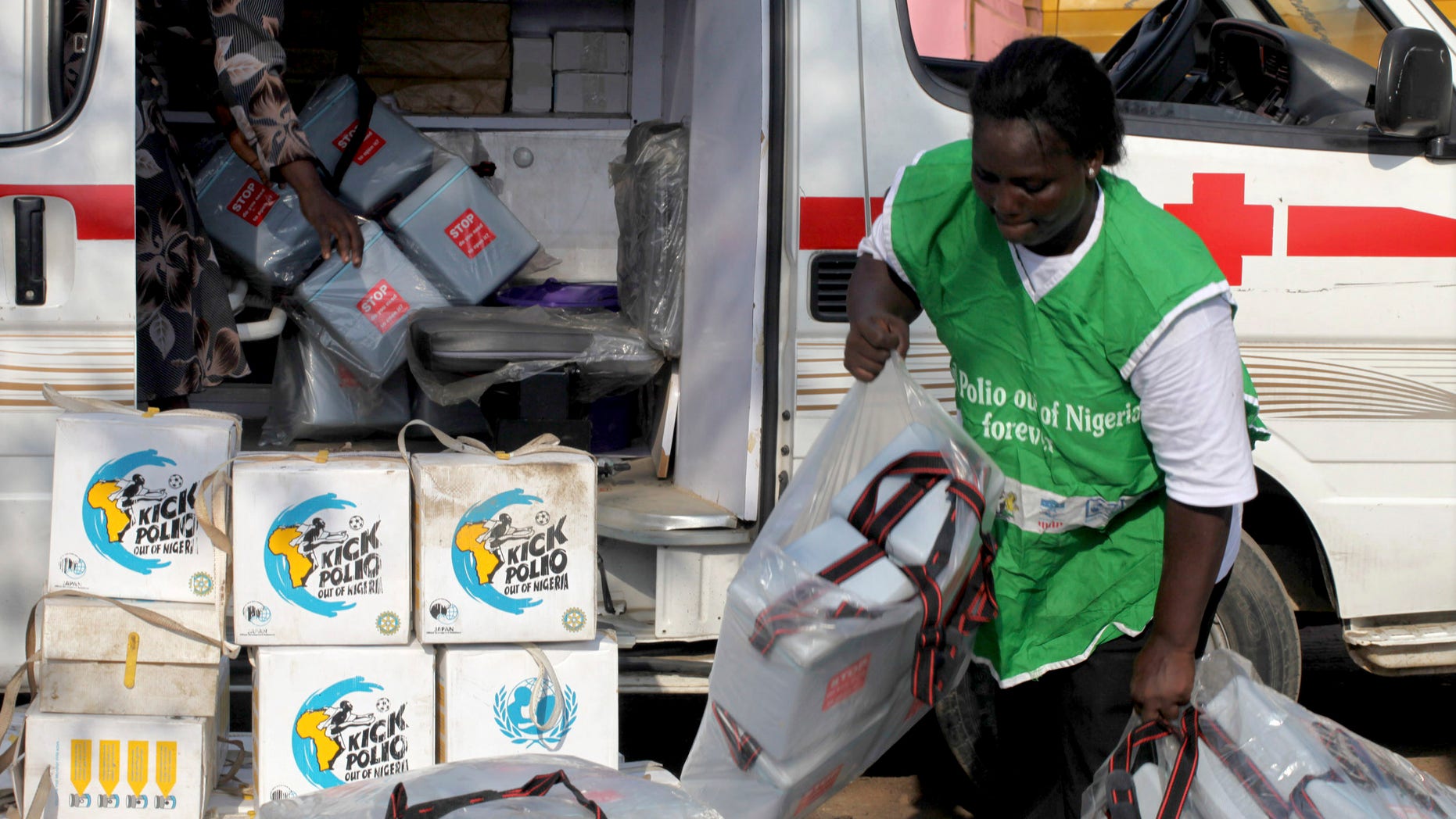 A local health worker carries vaccination kits into a vehicle at a distribution centre ahead of the start of a nationwide polio immunization campaign on Wednesday, in Lagos February 21, 2011. REUTERS/Akintunde Akinleye