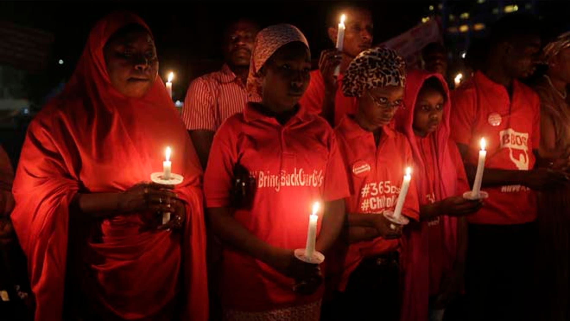 April 14, 2015: People hold candles during a vigil to mark the one year anniversary of the abduction of girls studying at the Chibok government secondary school, Abuja, Nigeria.
