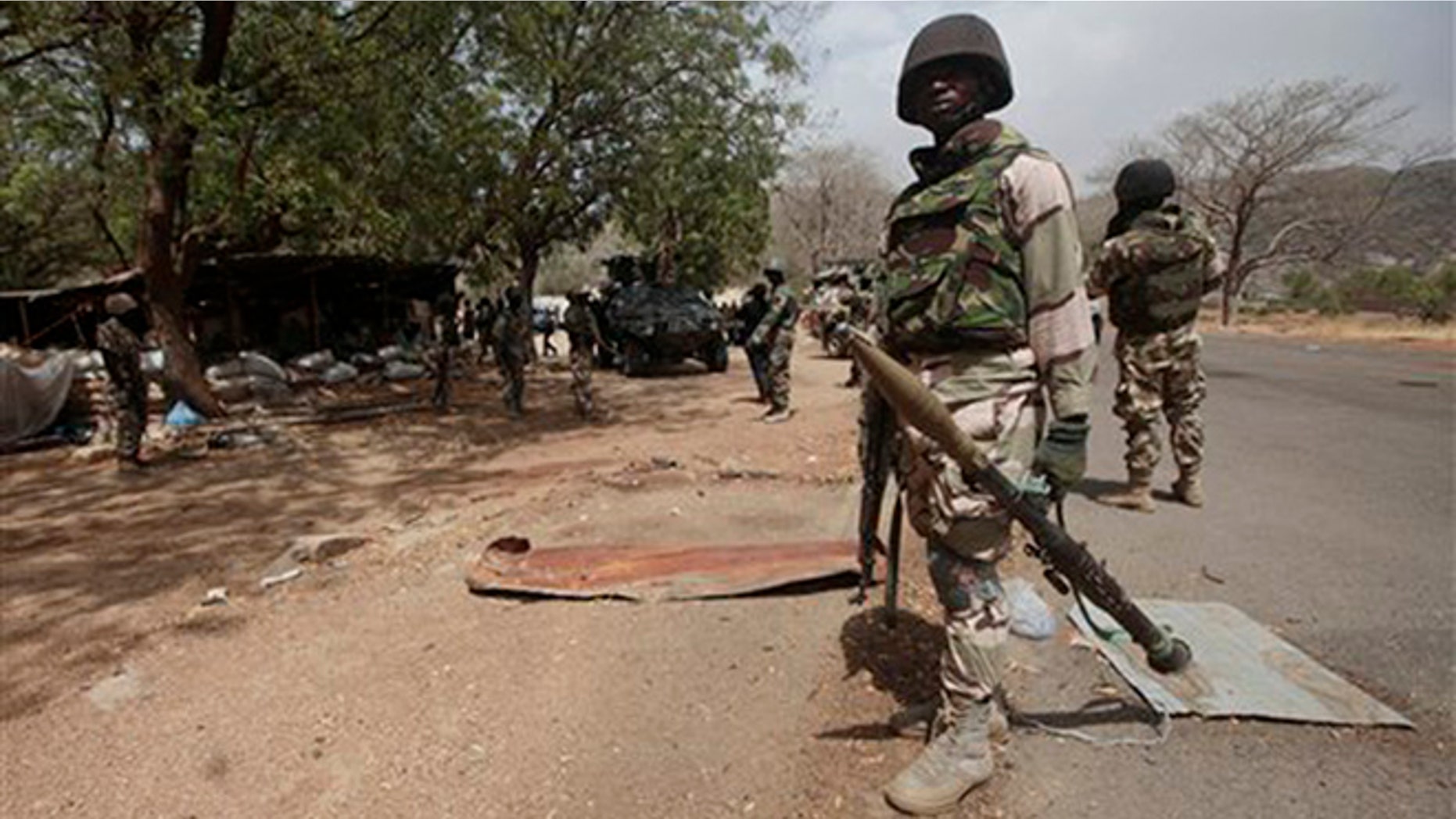 In this 2015 file photo, Nigerian Soldiers man a check point in Gwoza, Nigeria, a town newly liberated from Boko Haram. Nigeria's military says it is moving 200 girls and 93 women from a northeastern forest where they were rescued from Boko Haram extremists.