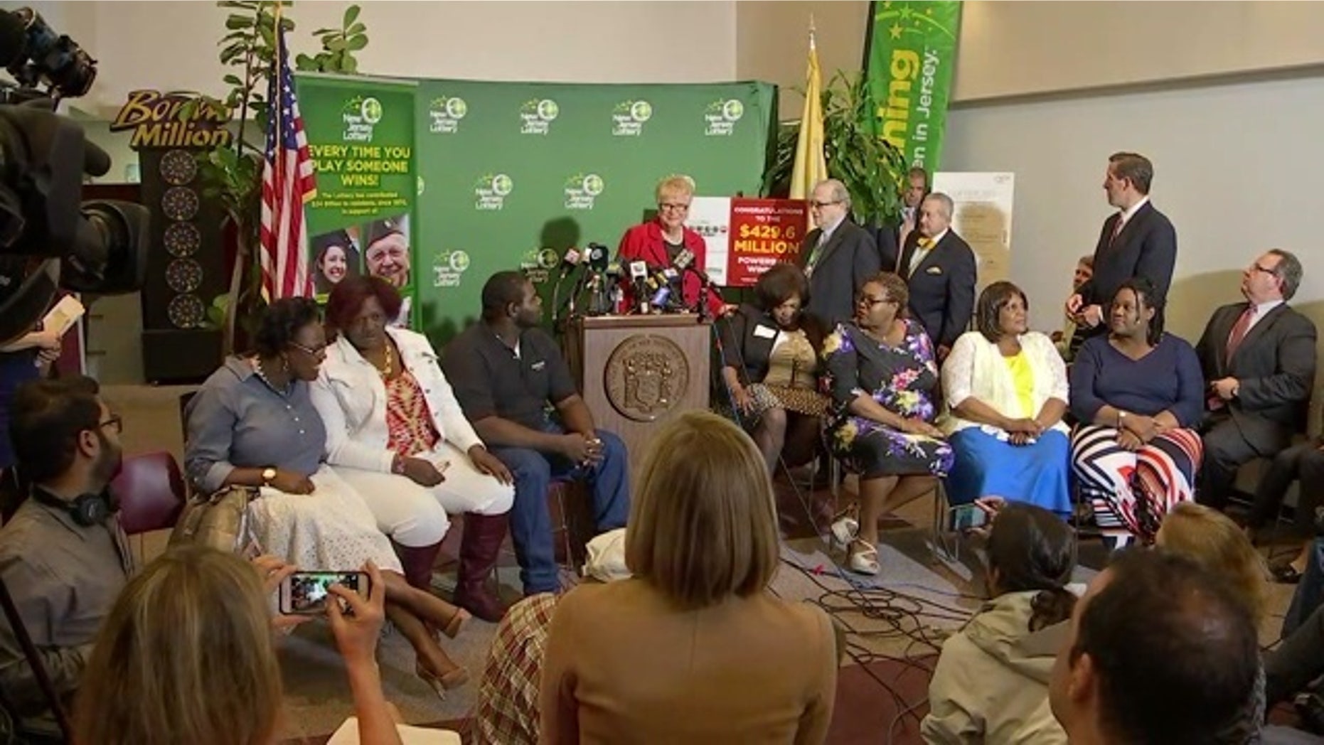 The Smith family with lottery officials at a news conference.