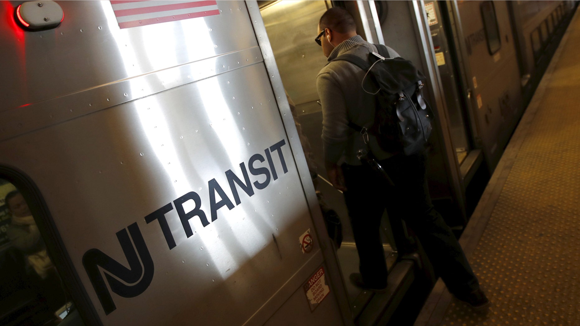 A commuter boards a New Jersey Transit commuter train bound for New York City at a station in Secaucus, N.J., March 10, 2016.