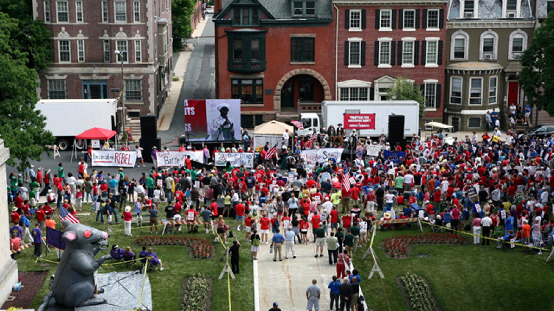 June 20: A large gathering of public employee union members and supporters protest in Trenton, N.J., outside the Statehouse over plans by Gov. Chris Christie to reduce benefits and limit collective bargaining over health care for public workers.