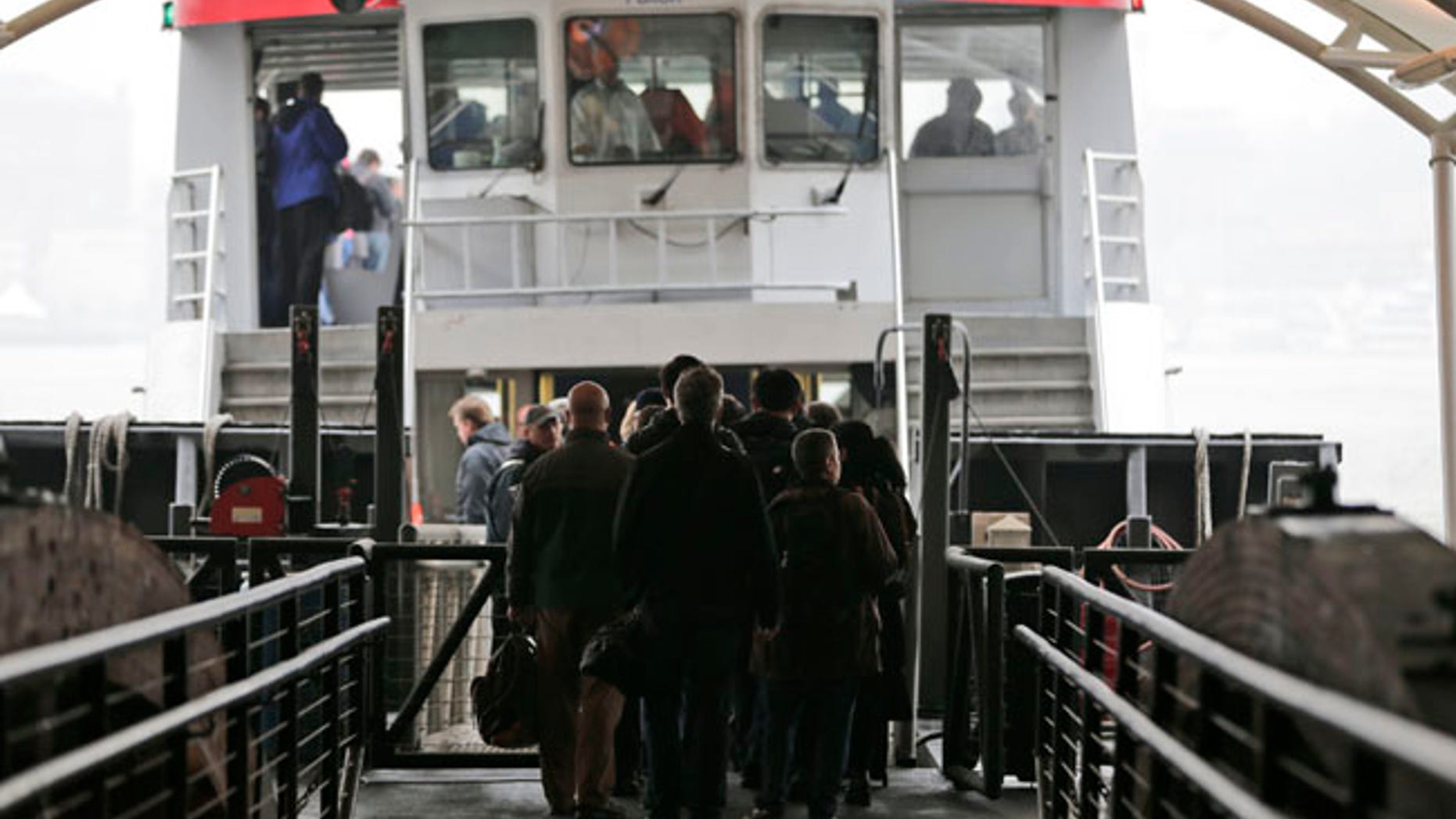 Commuters board a ferry bound for lower Manhattan in Hoboken, N.J., Tuesday, April 4, 2017. A minor derailment on Monday at Penn Station involving a New Jersey Transit train and other rail issues are causing major problems for New York City metro area commuters. (AP Photo/Seth Wenig)