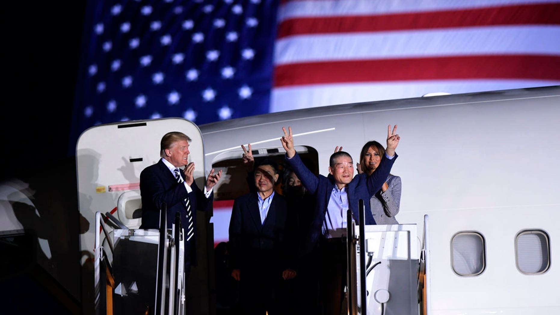 President Donald Trump, from left, greets Tony Kim, Kim Hak Song, seen in the shadow, and Kim Dong Chul, three Americans detained in North Korea for more than a year, as they arrive at Andrews Air Force Base in Md., Thursday, May 10, 2018. First lady Melania Trump also greets them at right. (AP Photo/Susan Walsh)