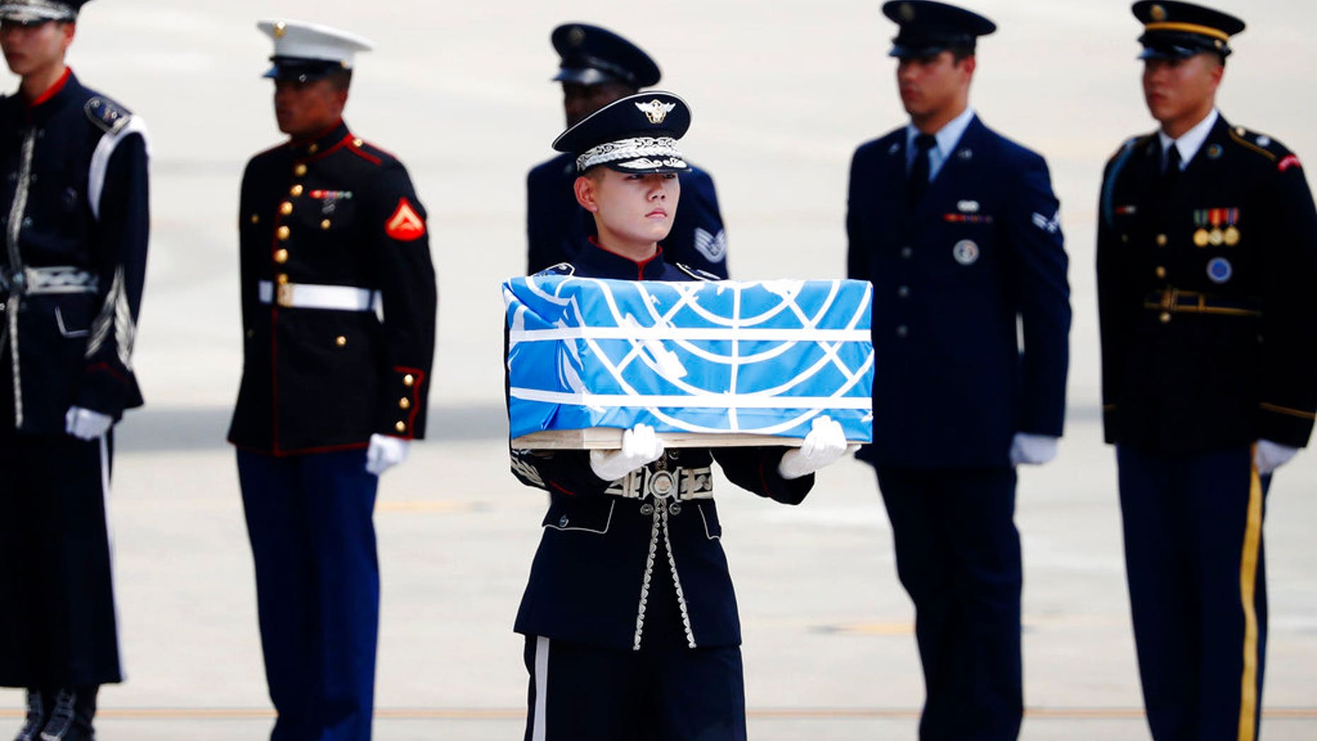 A soldier carries a casket containing a remain of a U.S. soldier who was killed in the Korean War during a ceremony at Osan Air Base in Pyeongtaek, South Korea, Friday, July 27, 2018. The U.N. Command said the 55 cases of war remains retrieved from North Korea will be honored at a ceremony next Wednesday at a base in South Korea. (Kim Hong-Ji/Pool Photo via AP)