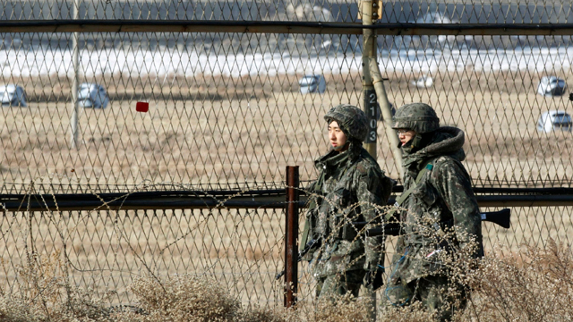 Jan. 27, 2013: South Korean army soldiers patrol along a barbed-wire fence in Paju, South Korea, near the demilitarized zone (DMZ) of Panmunjom.