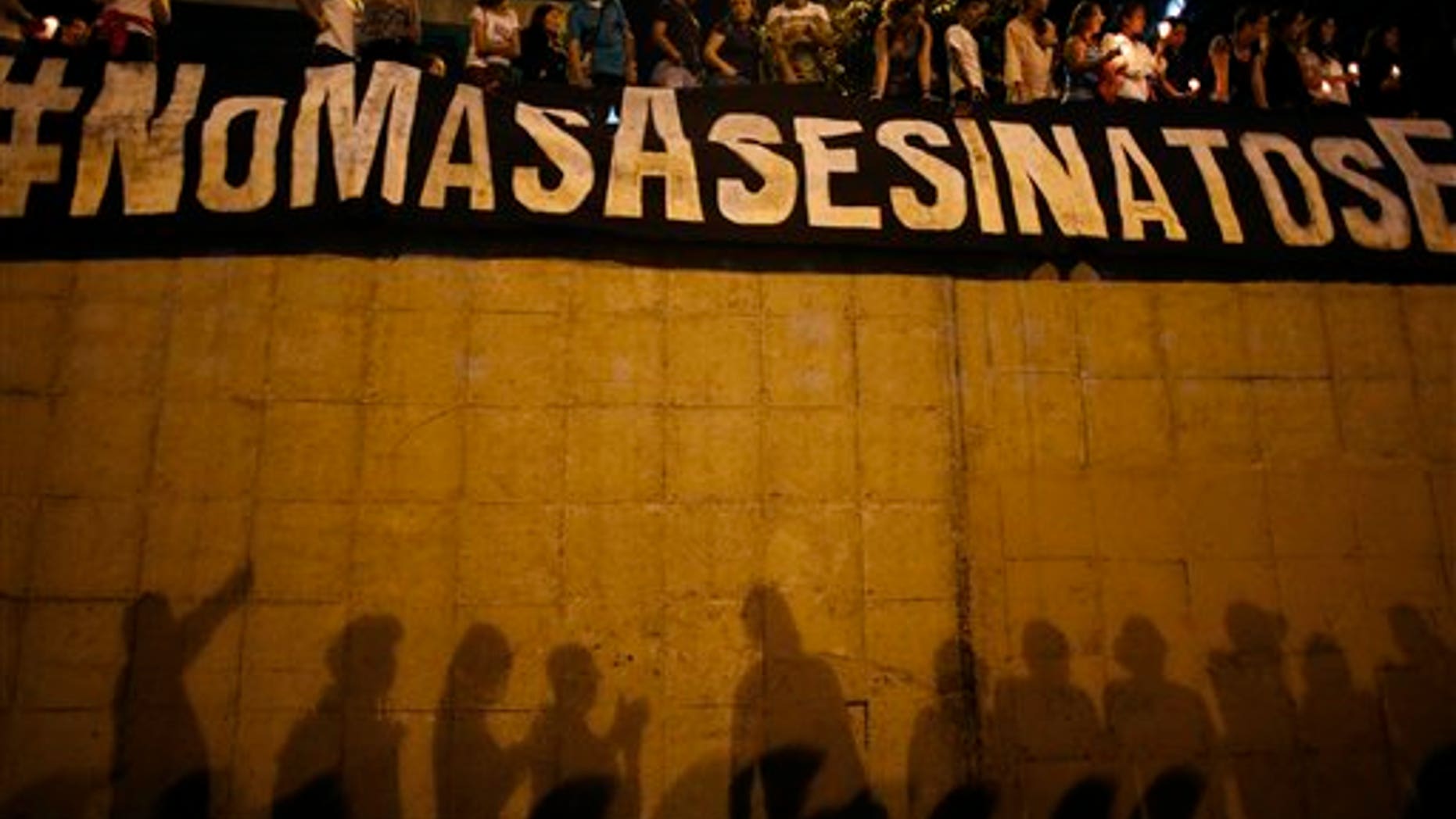Demonstrators display on June 8, 2017 a banner that reads "No More Killings" near the spot where protester Neomar Lander died.