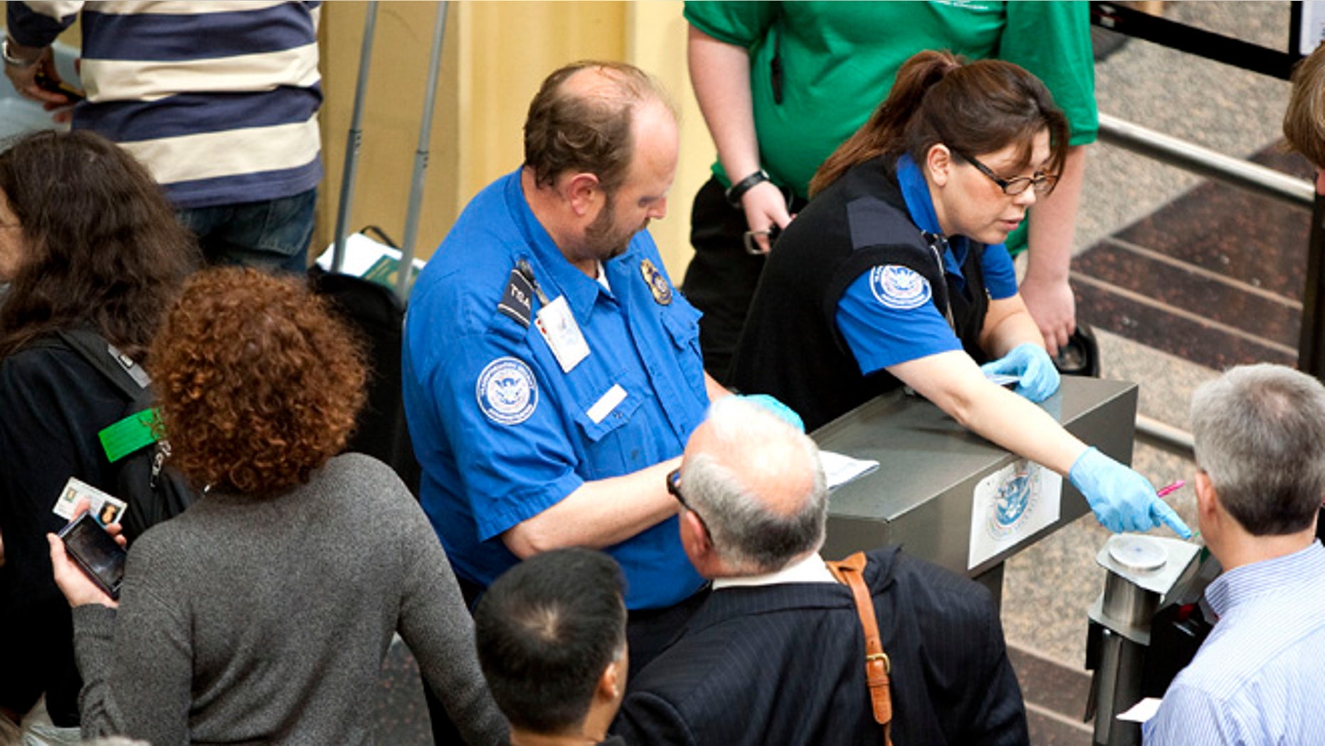 FILE: REUTERS: UNDATED: Transportation Security Administration employees check passenger IDs before they enter security screening at Reagan National Airport, outside Washington, D.C.