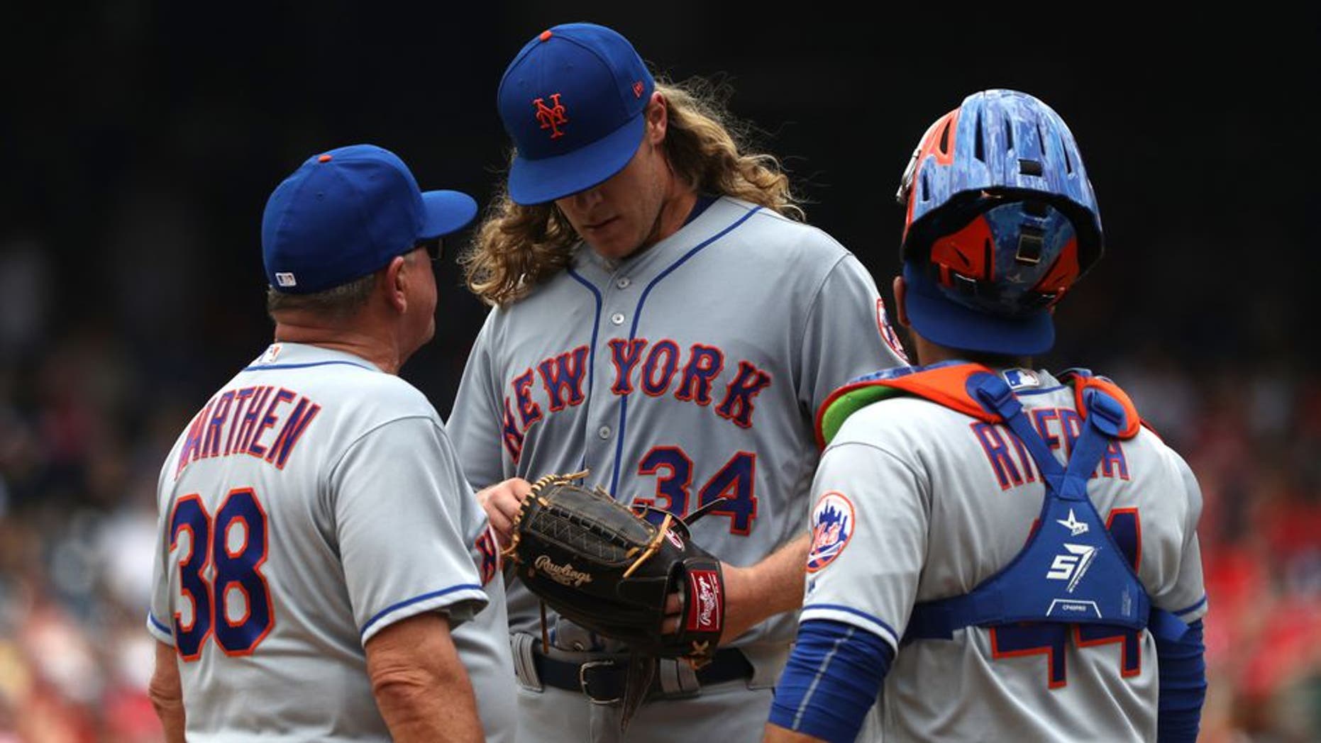 WASHINGTON, DC - APRIL 30: Starting pitcher Noah Syndergaard #34 of the New York Mets talks to coach Dan Warthen #38 and catcher Rene Rivera #44 in the first inning against the Washington Nationals at Nationals Park on April 30, 2017 in Washington, DC. (Photo by Patrick Smith/Getty Images)