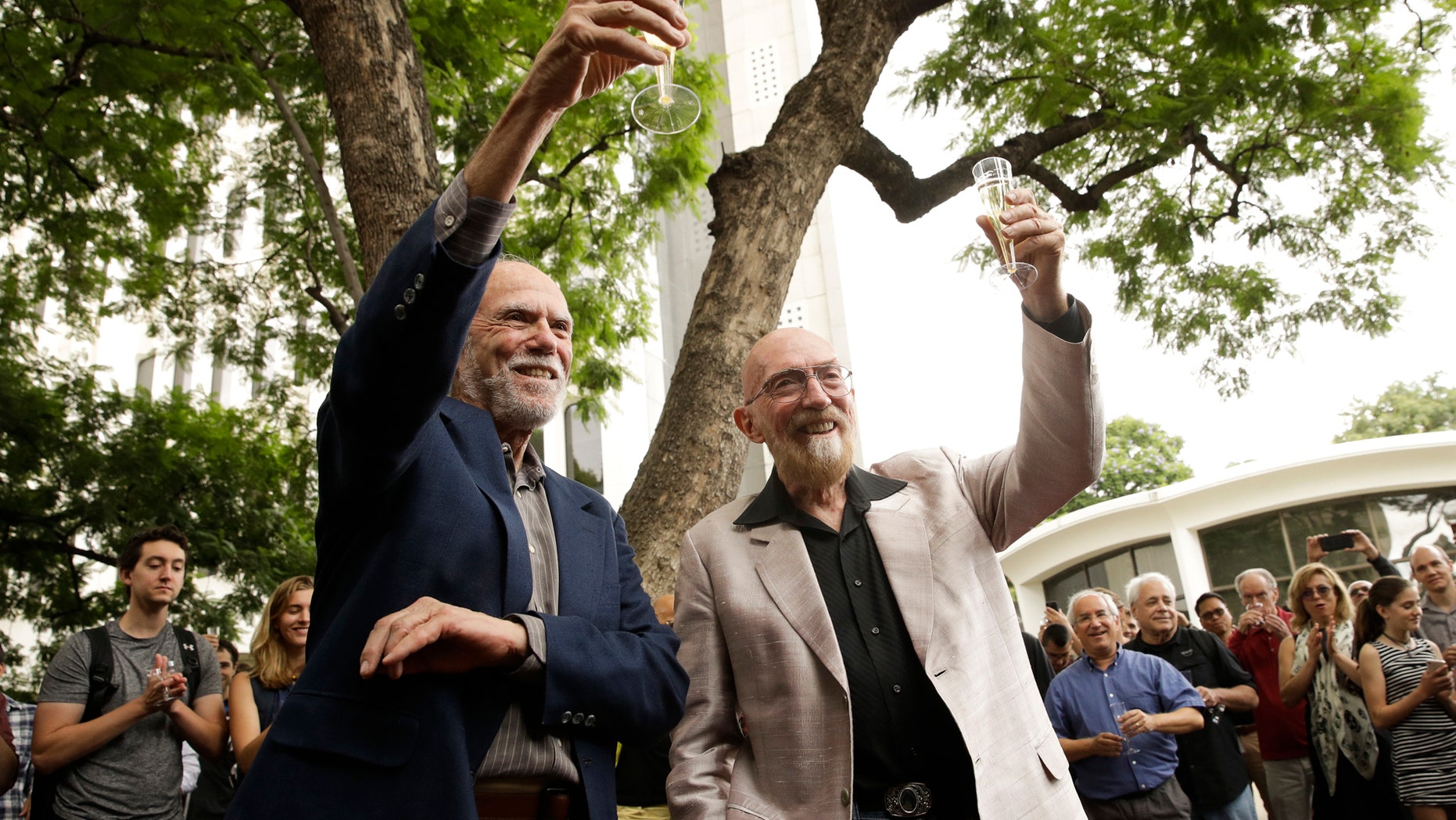 Scientists Barry Barish, left, and Kip Thorne, both of the California Institute of Technology, share a toast to celebrate winning the Nobel Prize in Physics Tuesday, Oct. 3, 2017, in Pasadena, Calif. Barish and Thorne won the Nobel Physics Prize on Tuesday for detecting faint ripples flying through the universe, the gravitational waves predicted a century ago by Albert Einstein that provide a new understanding of the universe. (AP Photo/Jae C. Hong)