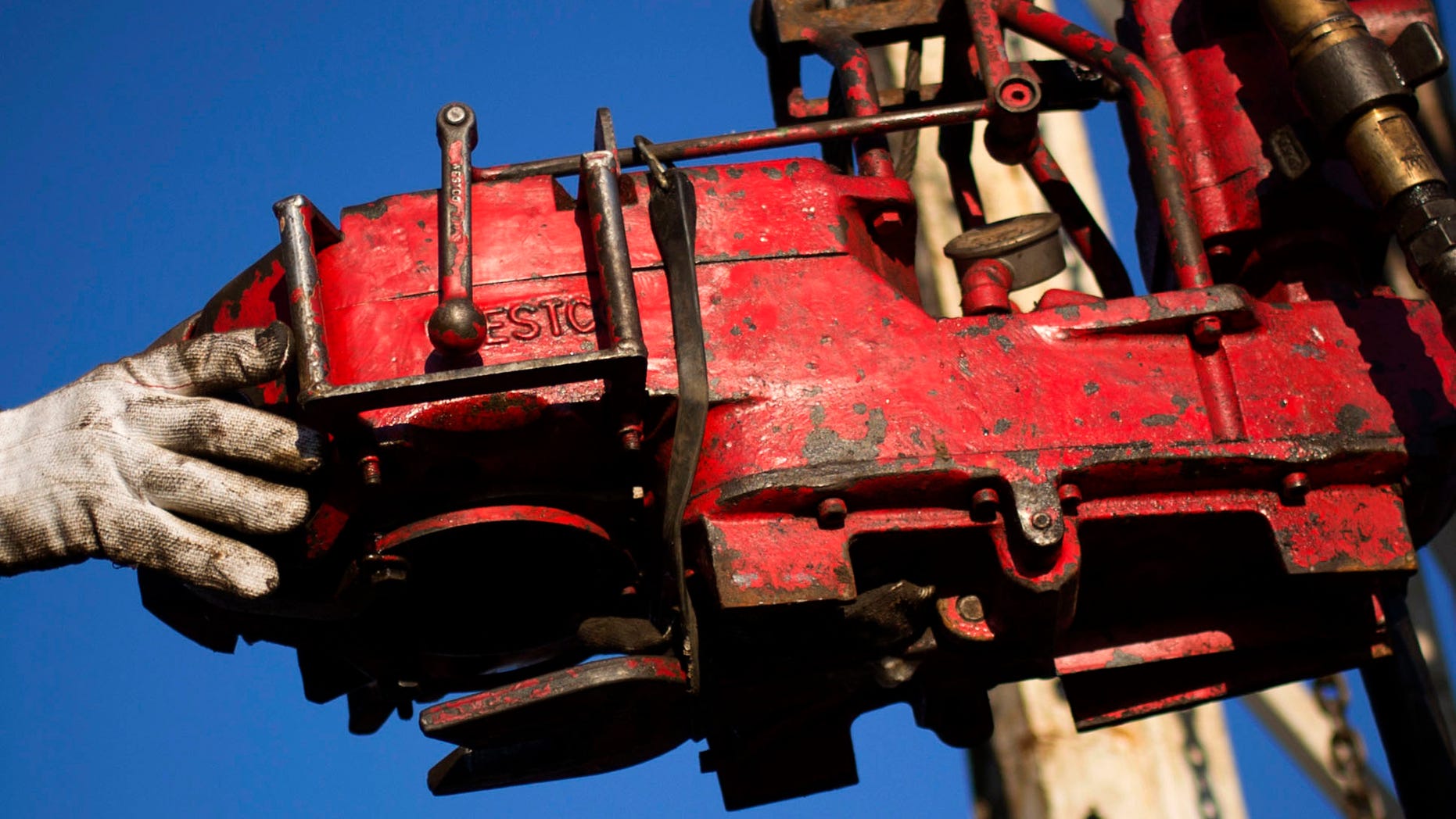 M arch 12: 2013: A man works on the rig of an oil drilling pump site in McKenzie County outside of Williston, North Dakota.