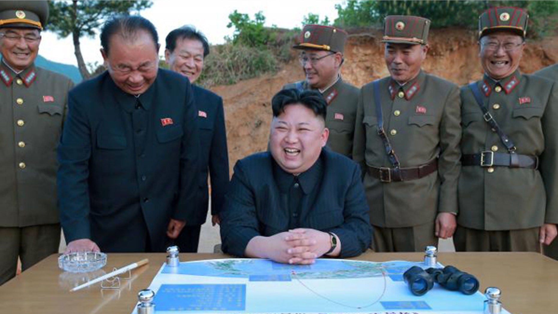 : North Korean leader Kim Jong Un reacts during the long-range strategic ballistic rocket test launch with Ri Pyong Chol (2nd L), Kim Jong Sik (C) and Jang Chang Ha (2nd R).