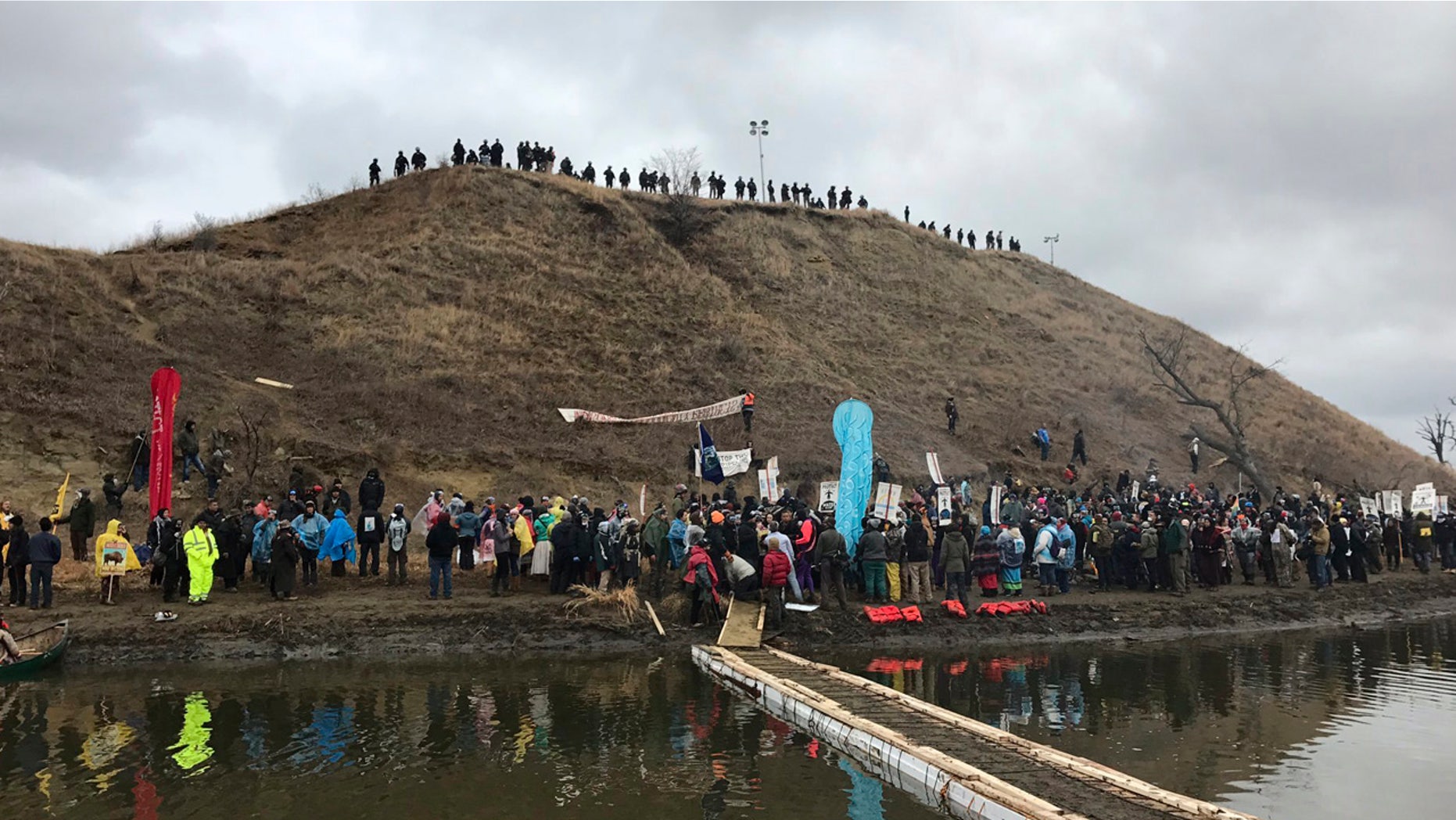 In this photo provided by Nancy Trevino, protesters against the Dakota Access oil pipeline gather at and around a hill, referred to as Turtle Island, where demonstrators claim burial sites are located, Thursday, Nov. 24, 2016 in Cannon Ball, N.D.