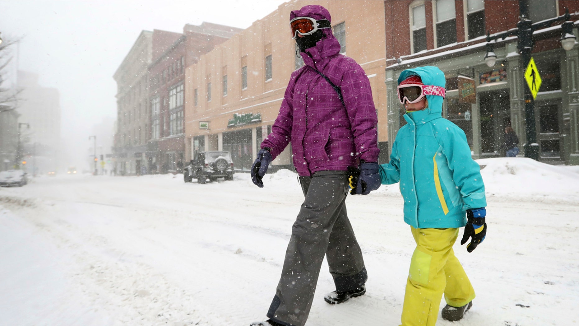 Christine Stack and her daughter, Carina Stack, 6, wear goggles while walking during a snowstorm, Thursday, Feb 9, 2017, in Portland, Maine.
